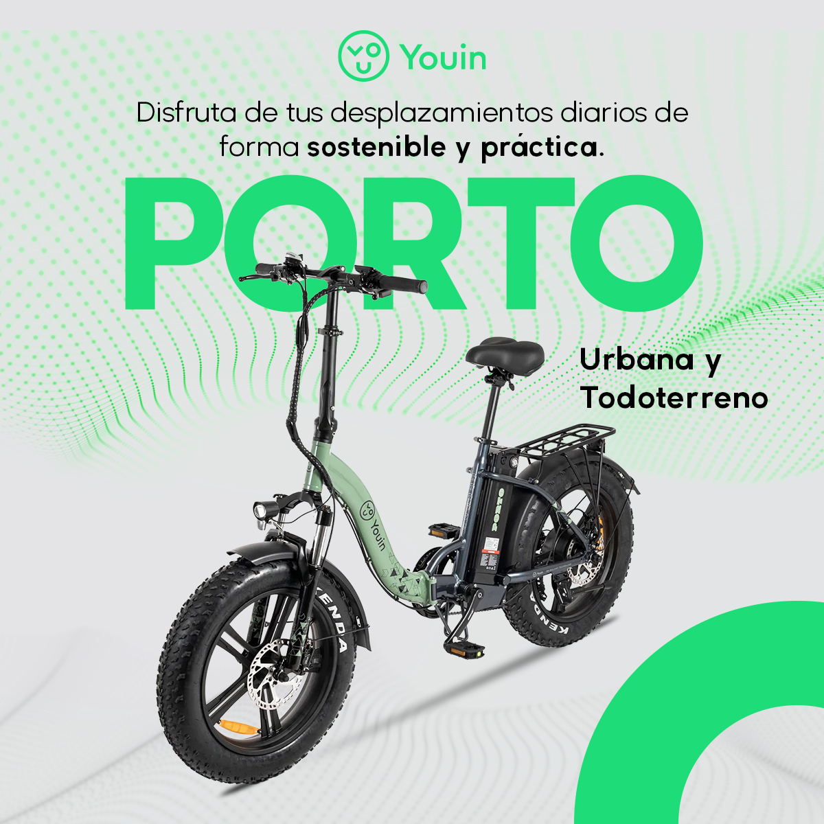 Una e-bike pieghevole verde chiaro con pneumatici grassi in primo piano.