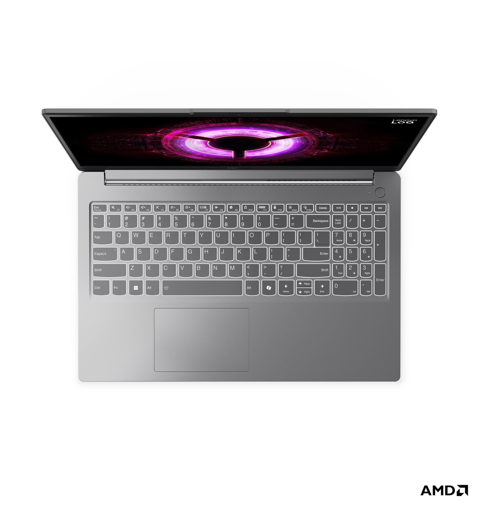 Un laptop argentato con tastiera retroilluminata e grafica a cerchio rosa sullo schermo.