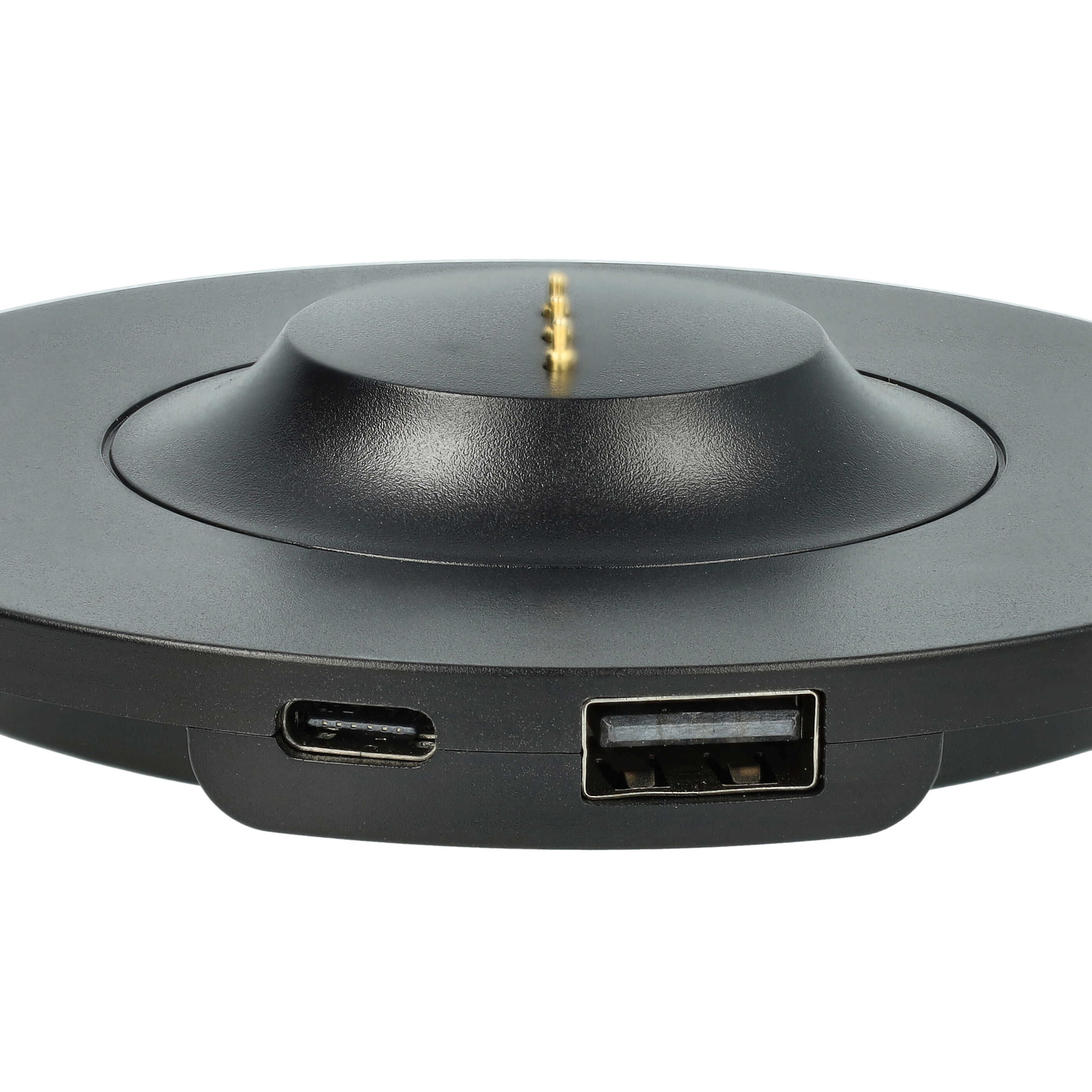 Ein schwarzes Ladegerät mit USB- und USB-C-Anschlüssen und goldenen Stiften.