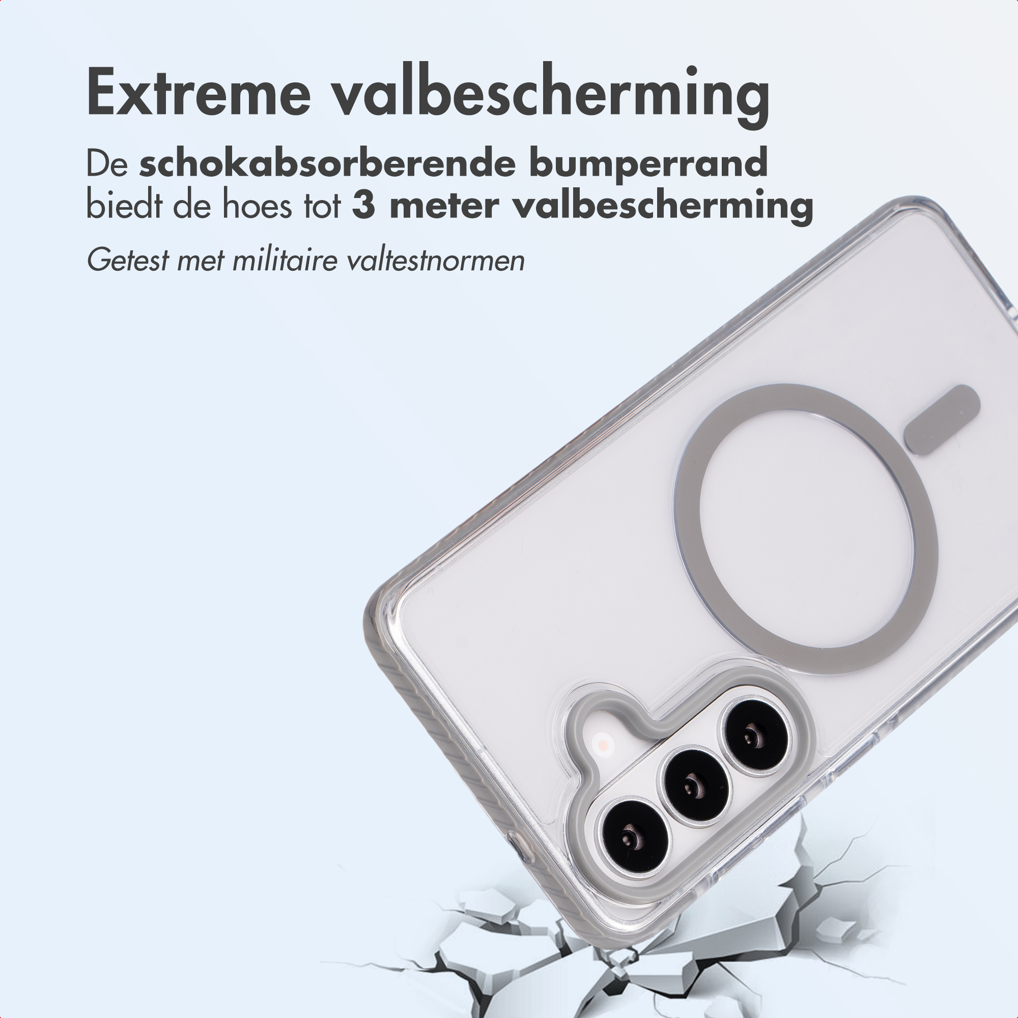 Transparante telefoonhoes met MagSafe ring valt op gebarsten grond.