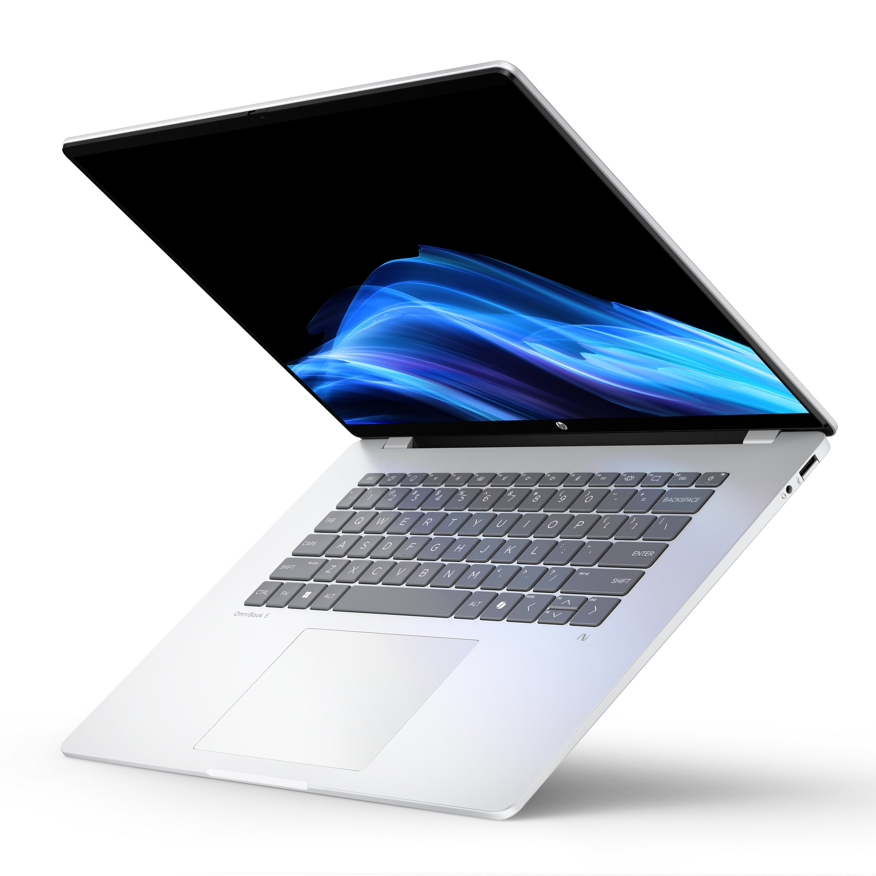 Laptop argentato con schermo aperto che mostra onde blu astratte. Tastiera e trackpad visibili.