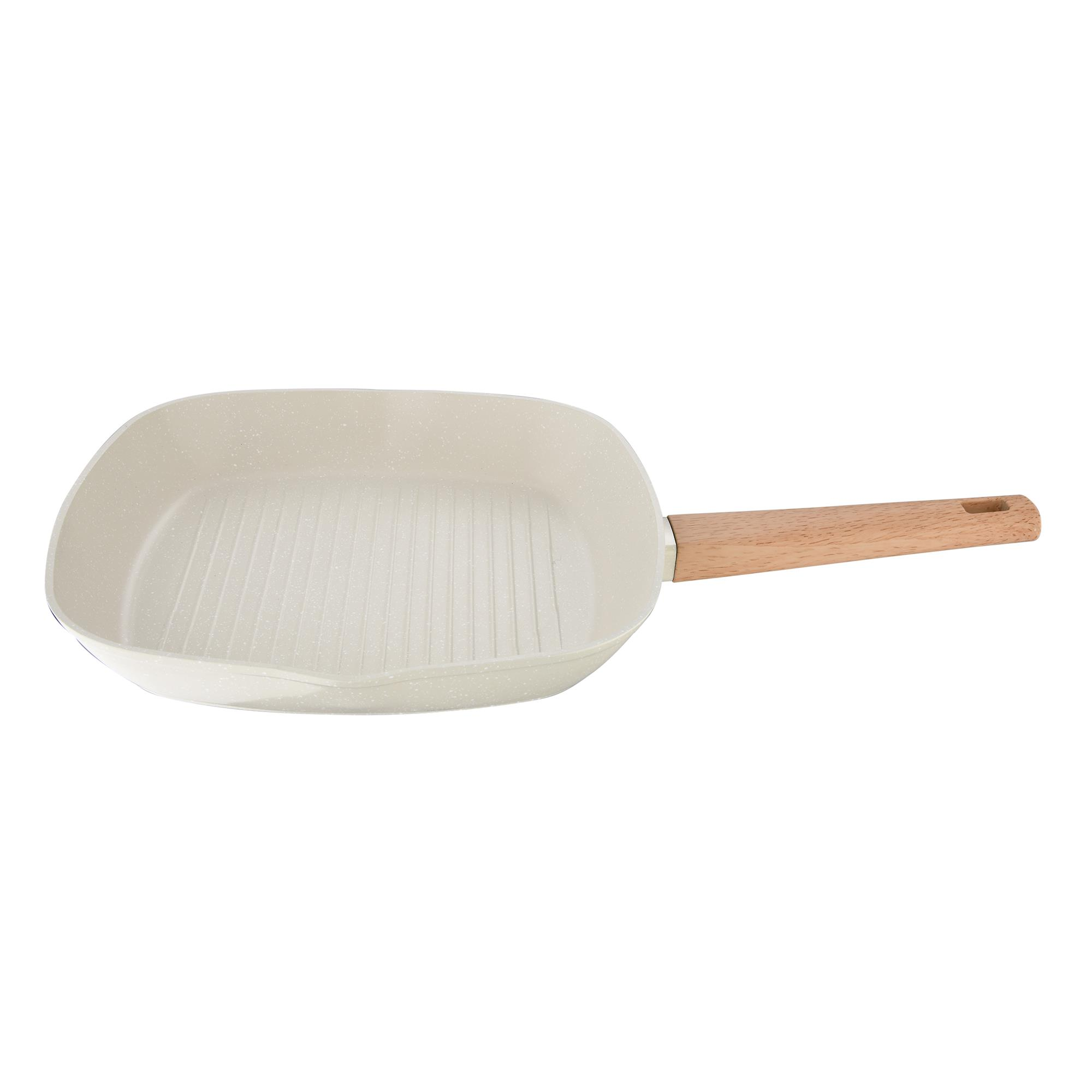 Una sartén grill color crema con mango de madera y fondo acanalado.