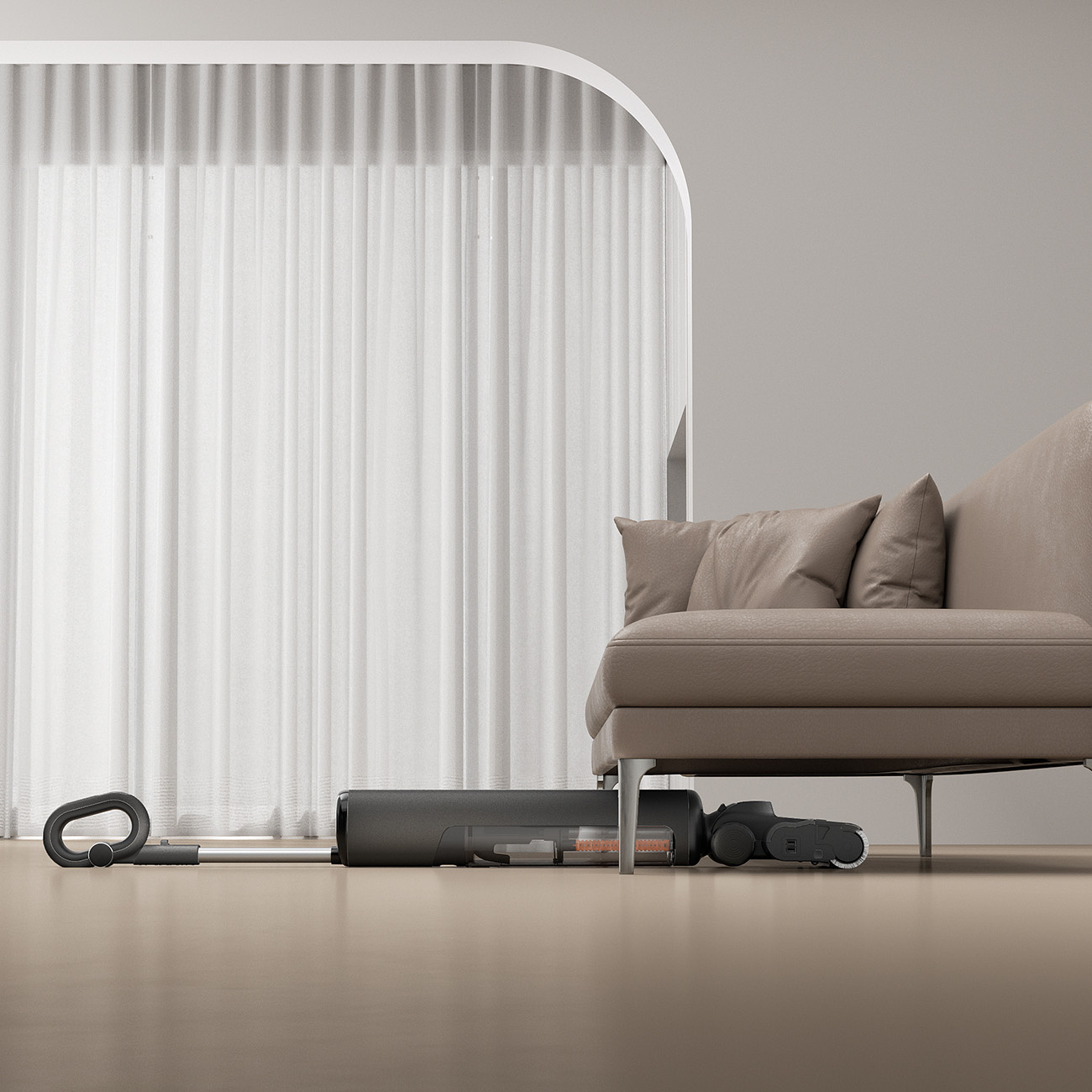 Ciemny odkurzacz leży na podłodze obok brązowej kanapy.