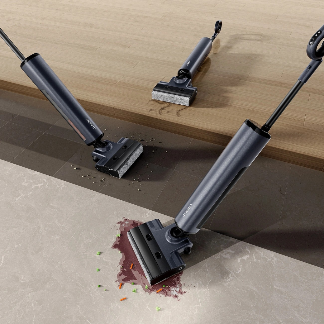 Trzy ciemne odkurzacze do podłóg na drewnianej i kafelkowej podłodze.