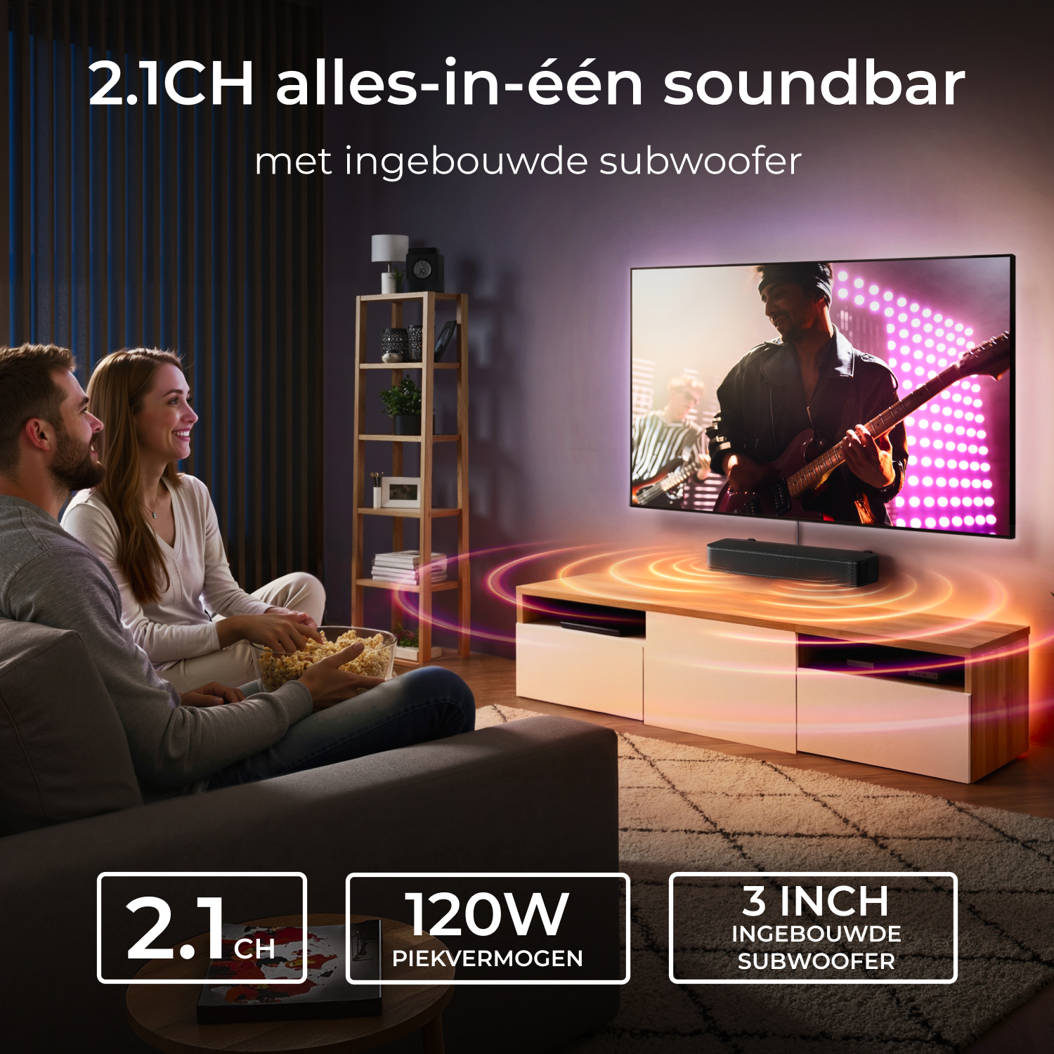 A couple eats popcorn on the couch while a man plays guitar.