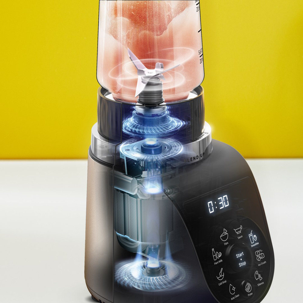 Ein Mixer mit einem Glas voller Fruchtstücke, detaillierter Motoraufbau.