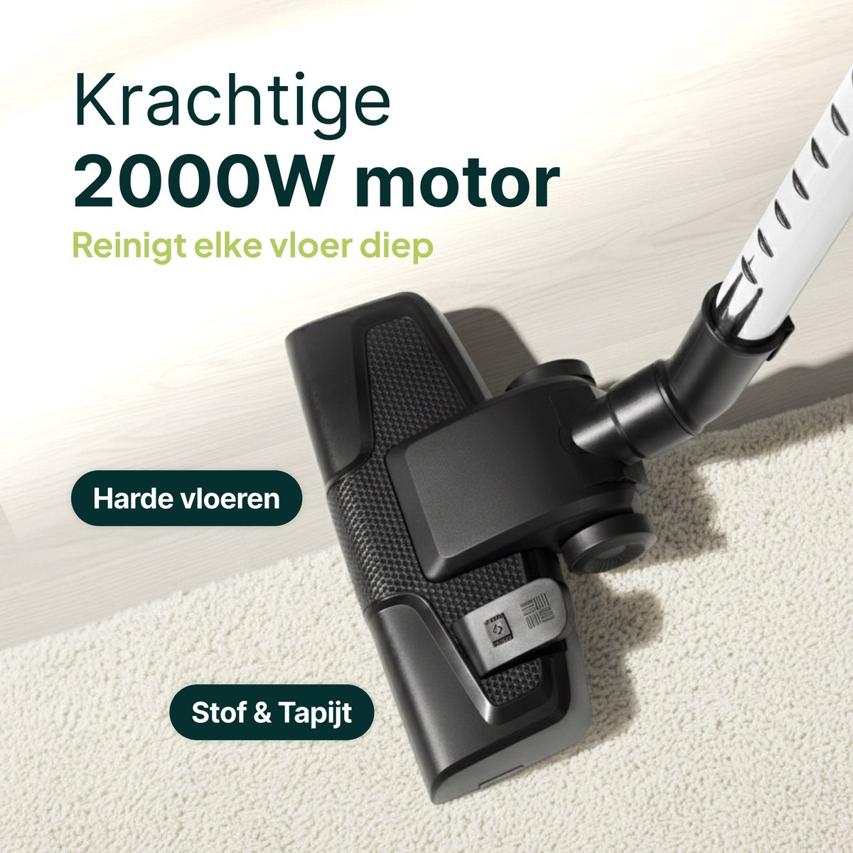 A black vacuum cleaner head on a light carpet and wooden floor.