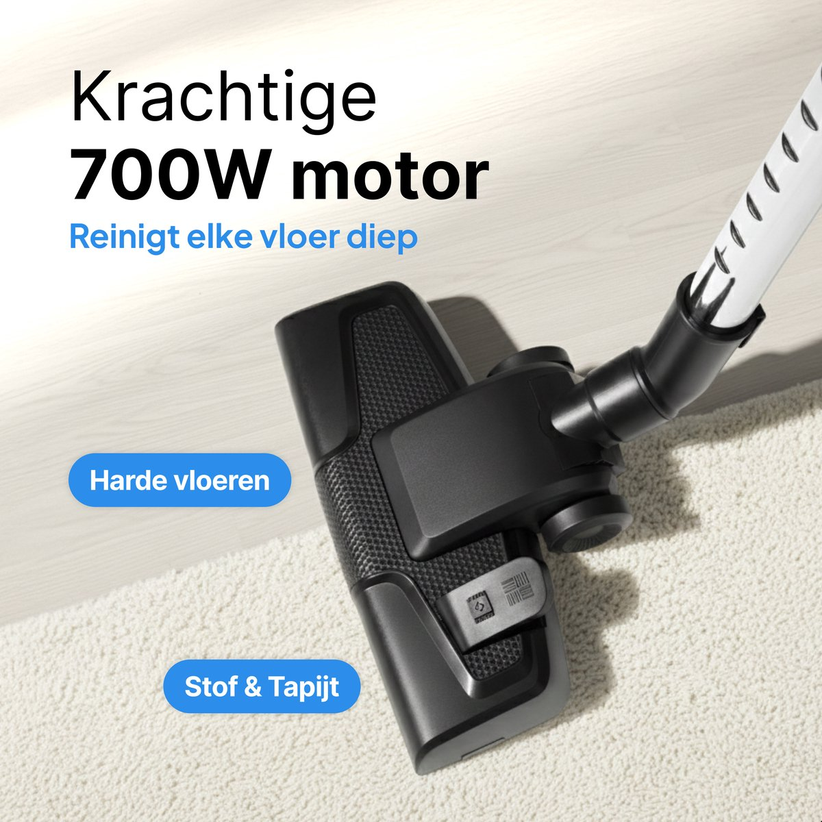 Black vacuum cleaner head on a light carpet and wooden floor.