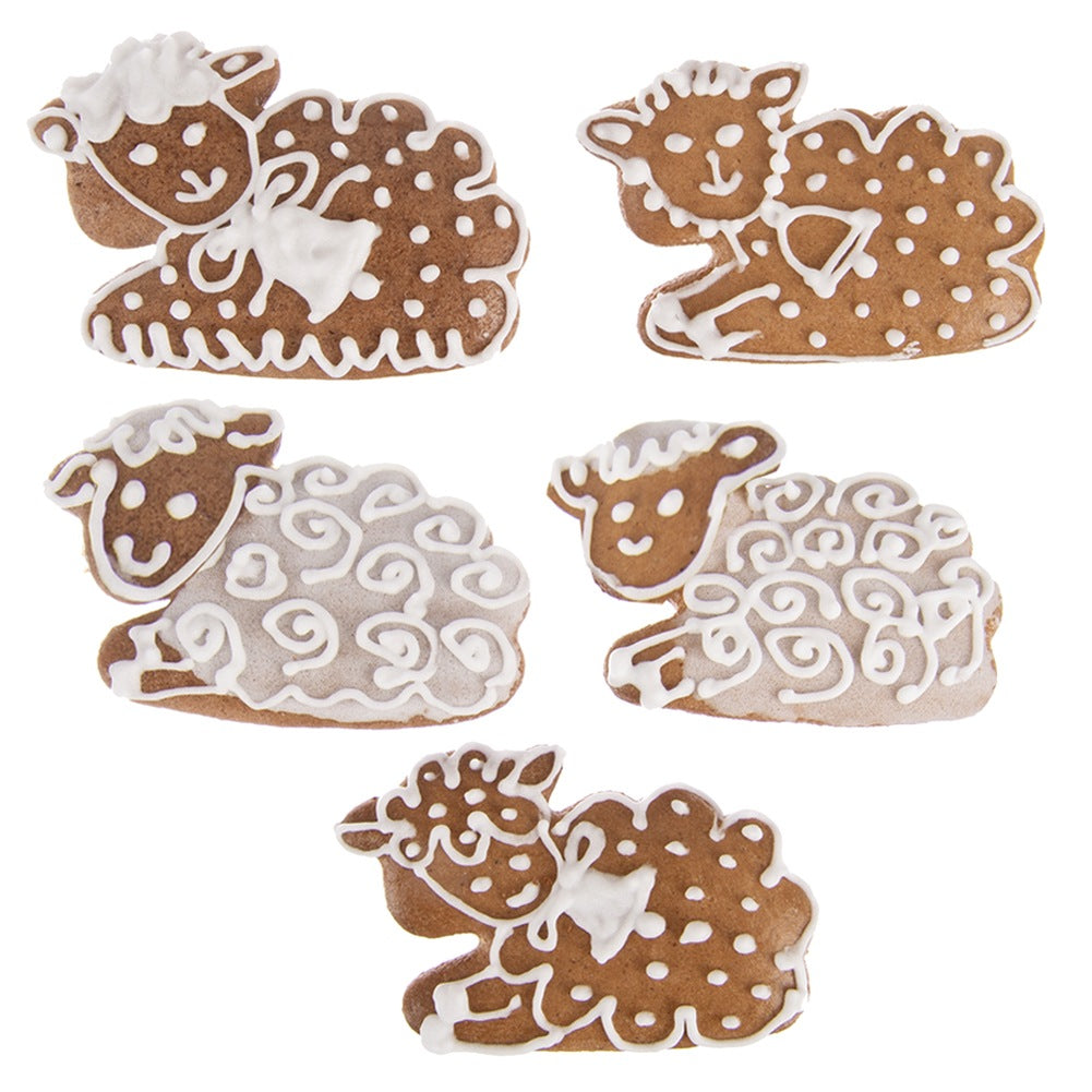 Cinco galletas de jengibre con forma de oveja decoradas con glaseado blanco.