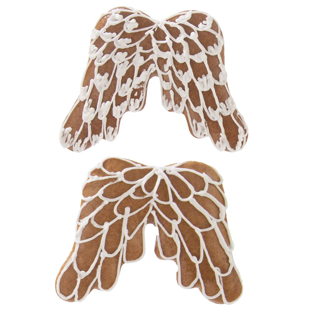 Dos galletas de alas de ángel marrones decoradas con glaseado blanco.