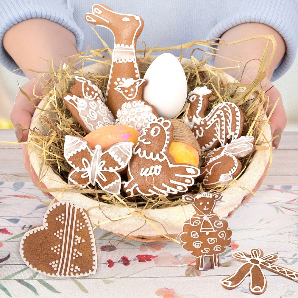 Cesta de Pascua con pan de jengibre, huevo y heno.