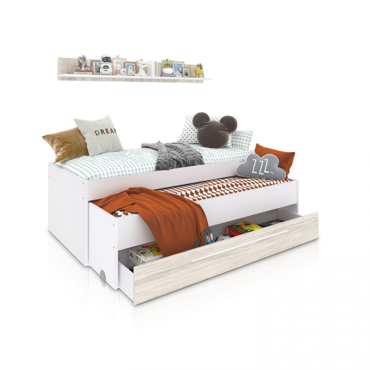 Una cama infantil blanca con cama nido y cajones. Decorada con cojines y mantas.