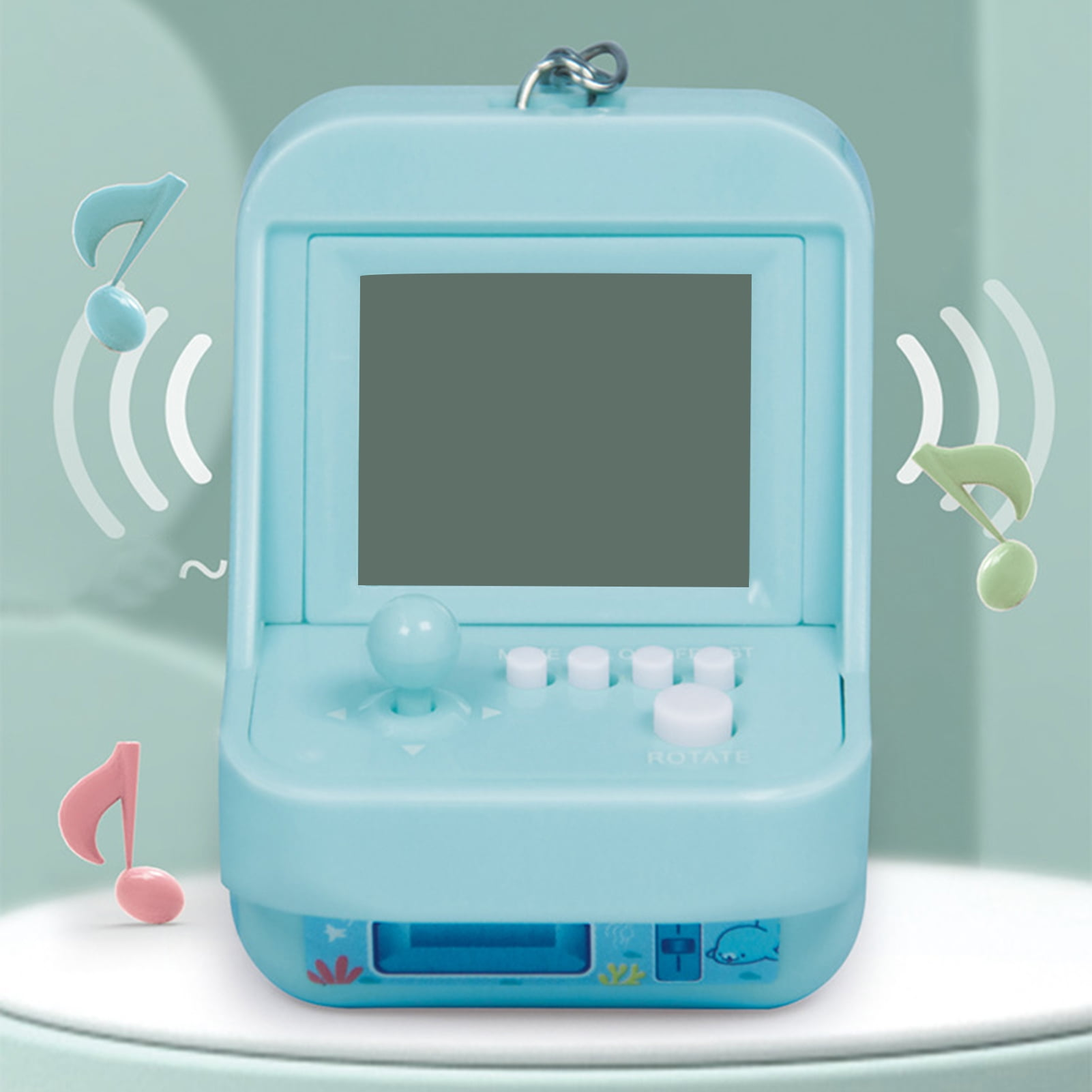 Ein hellblaues Handheld-Spiel mit Joystick, Knöpfen und Noten-Symbolen.