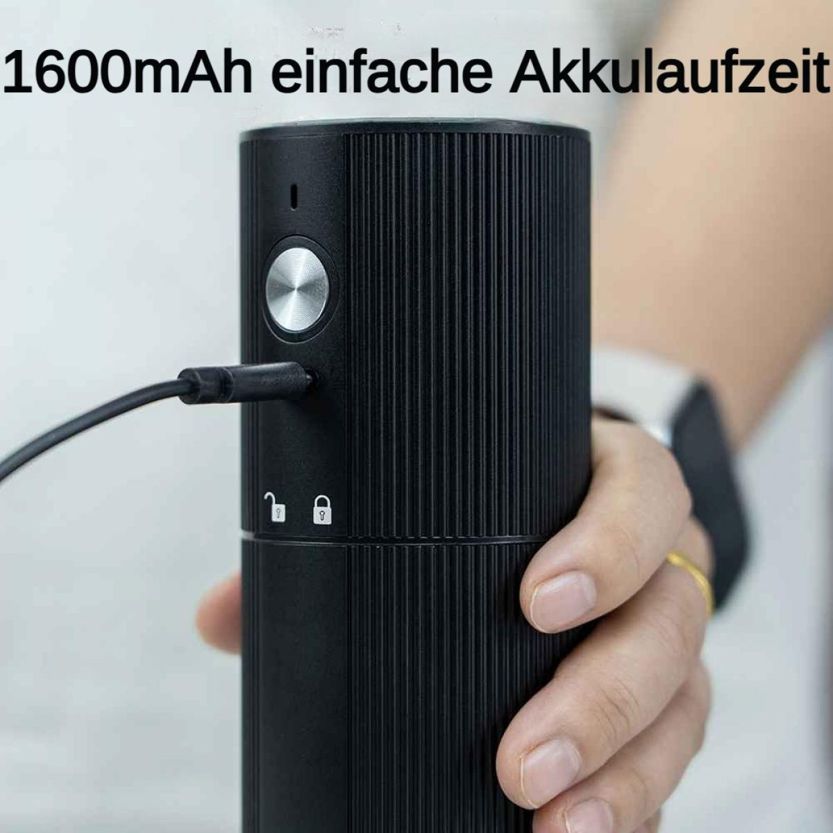 Schwarzer Zylinder mit Ladeanschluss, gehalten von einer Hand.
