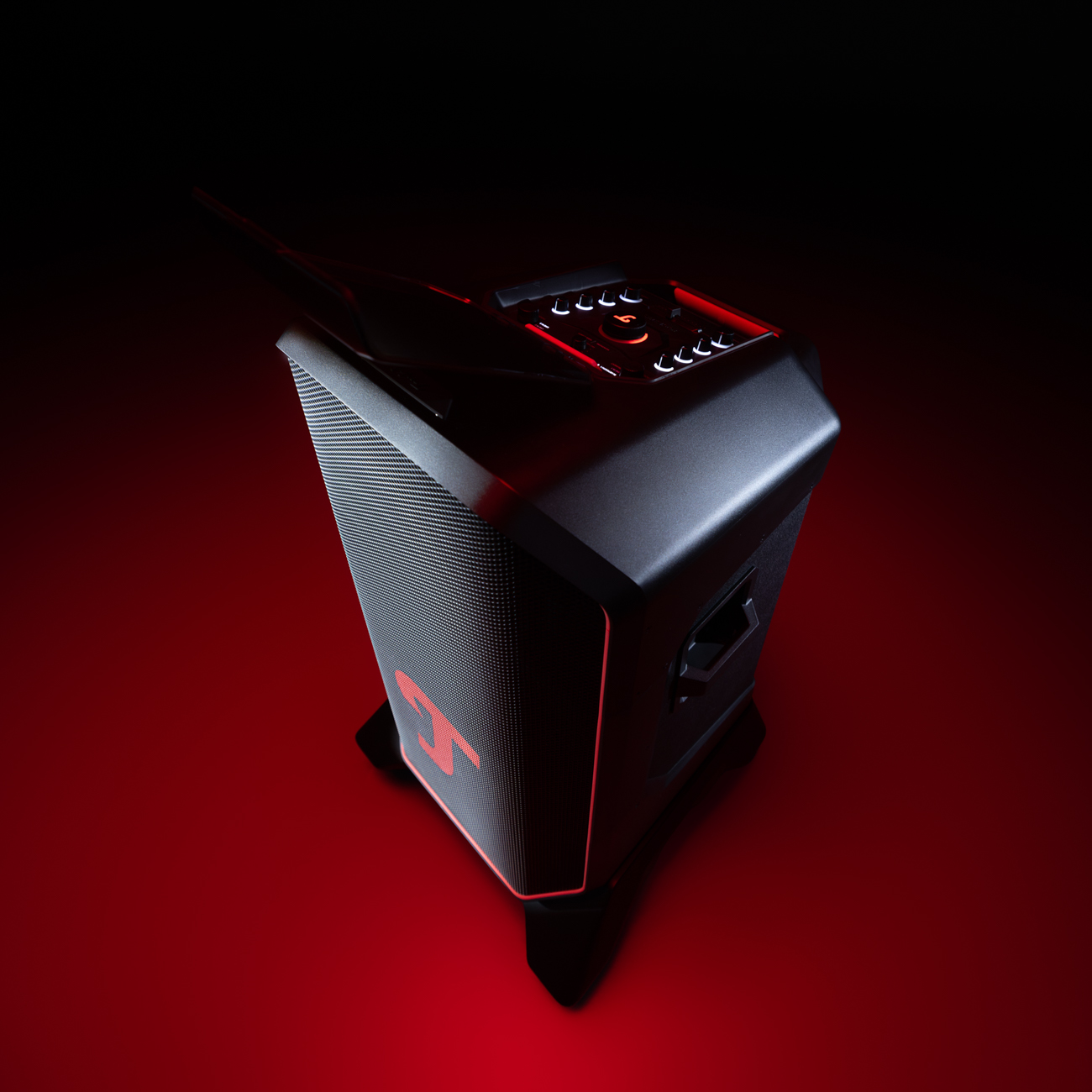 Uno speaker nero con accenti rossi si trova su uno sfondo rosso.
