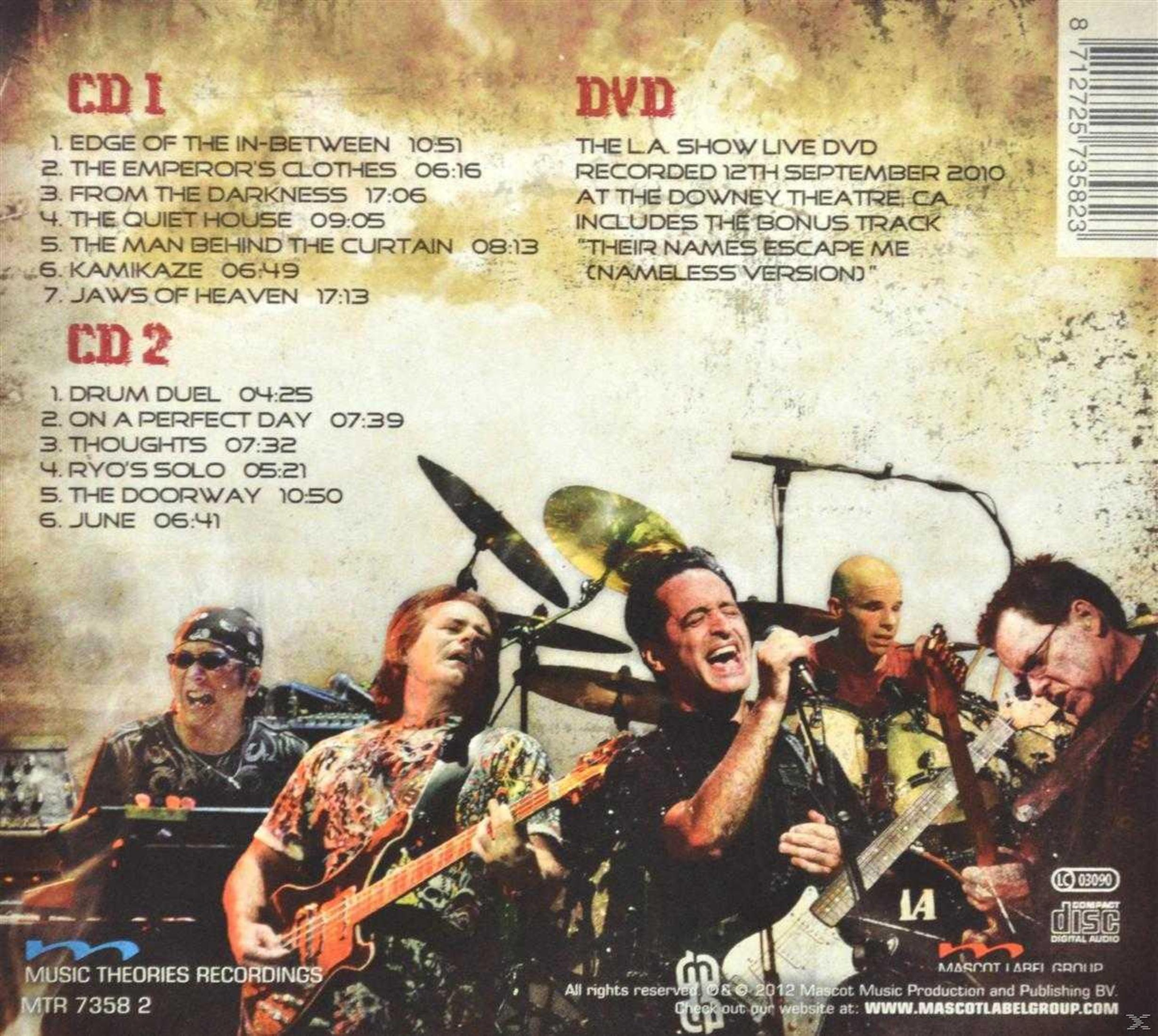 Band plays live, tracklist left, DVD info right. Aged yellow background.