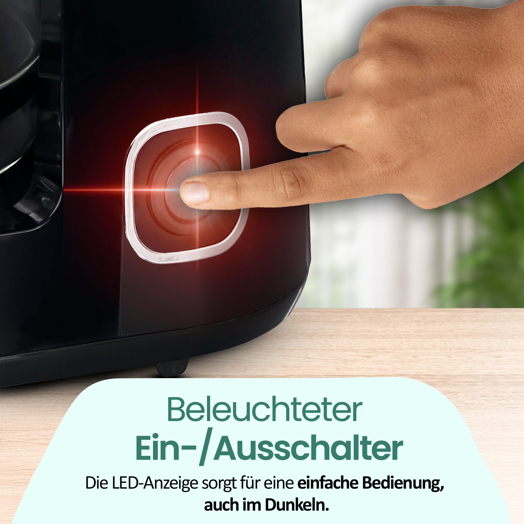 Ein Finger drückt einen beleuchteten roten Ein-/Ausschalter an einem schwarzen Gerät.