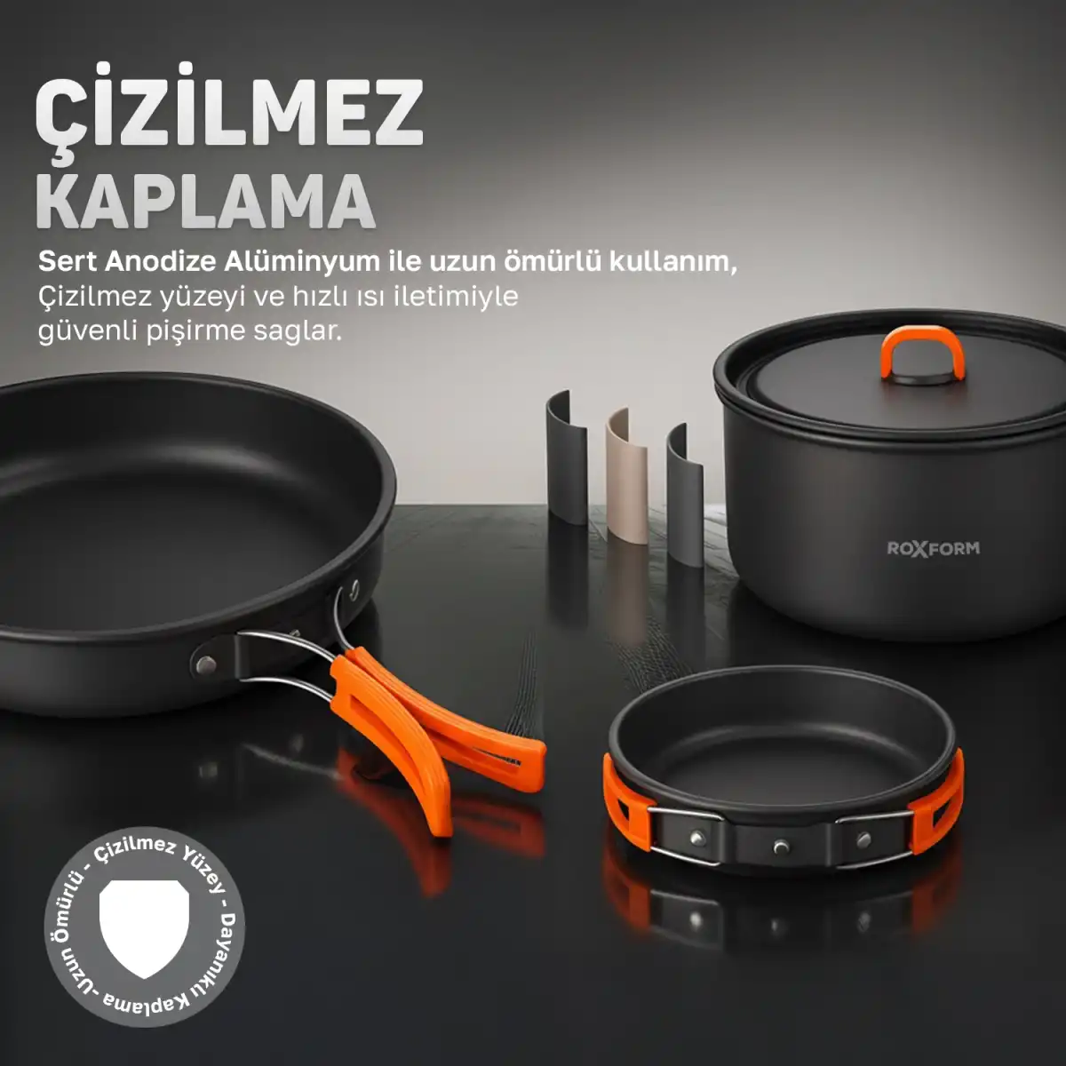 Yapışmaz kaplamalı tencere seti: turuncu saplı tava, tencere ve kase.