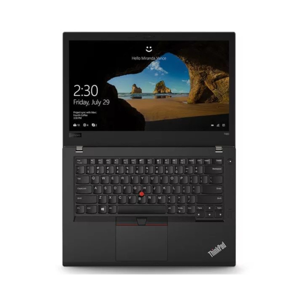 Ordinateur portable noir avec clavier rétroéclairé et scène de plage à l'écran.