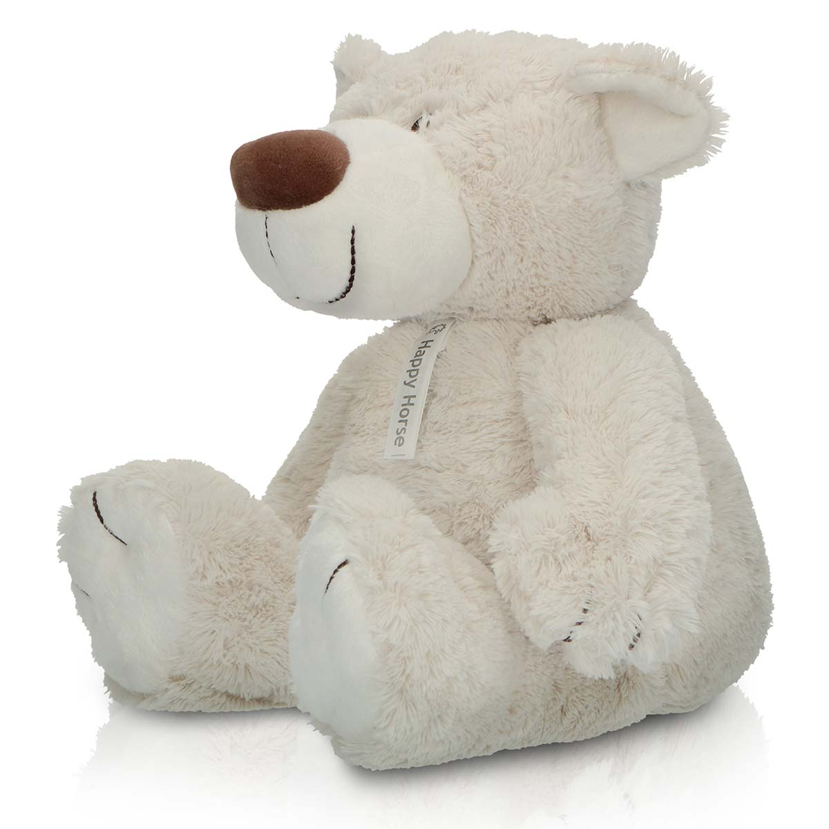 A soft, cream-colored teddy bear sits upright with a brown nose and a smile.