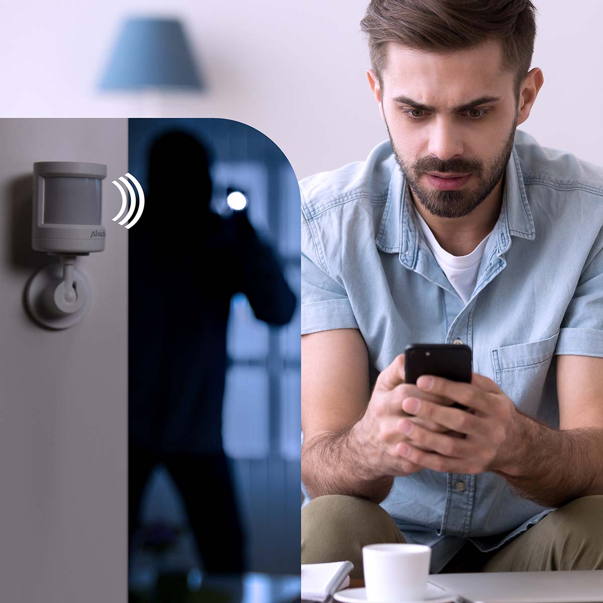 Man looks at phone as motion sensor detects dark figure with flashlight.