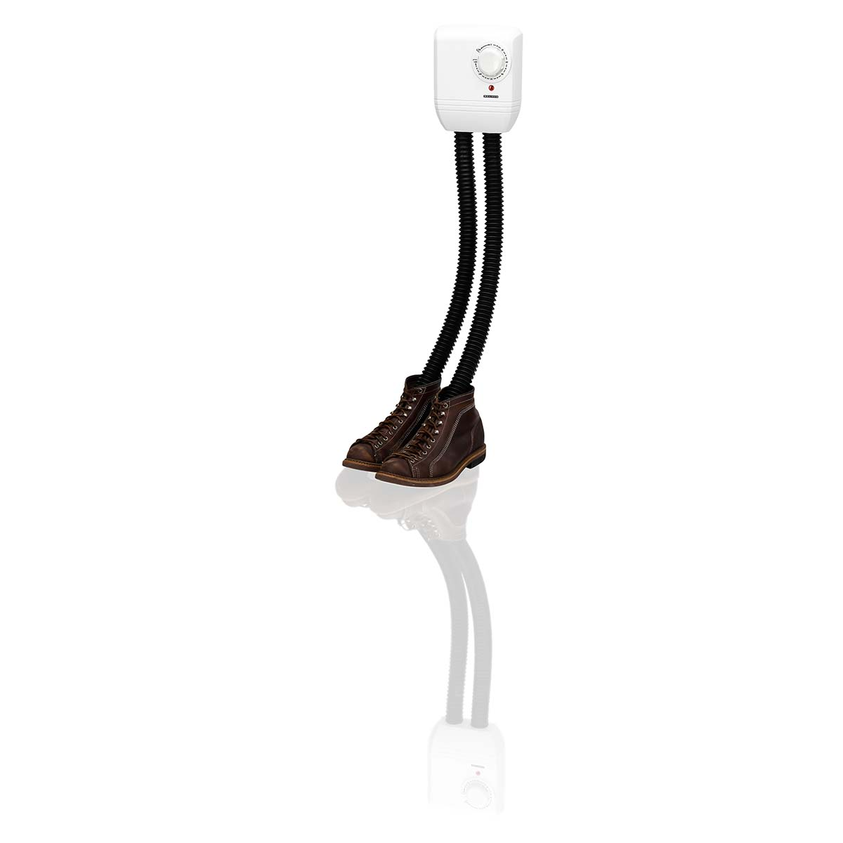 A white shoe dryer dries brown boots using black hoses.