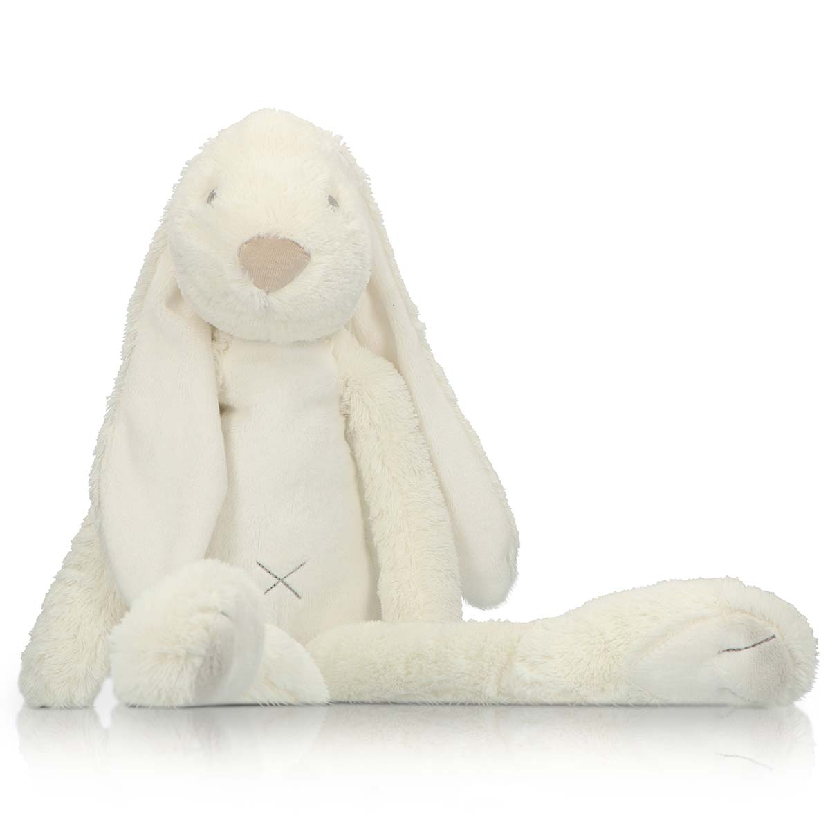 A cream-colored plush bunny sits with legs extended, white background.