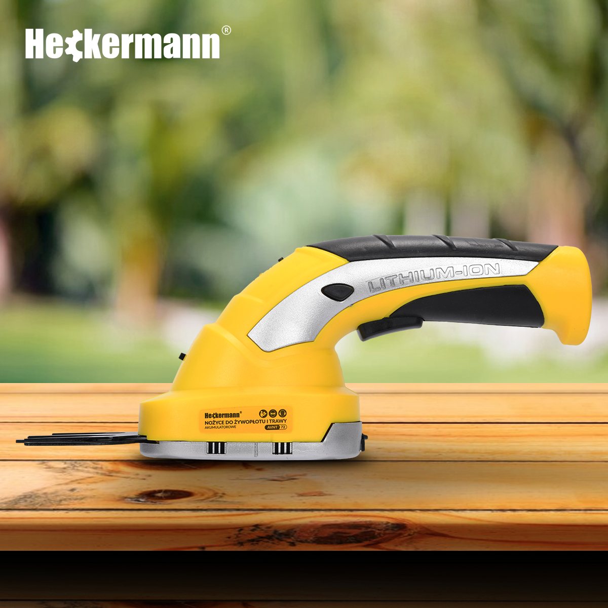 Żółta podkaszarka Heckermann litowo-jonowa z czarnym uchwytem leży na drewnianym stole.