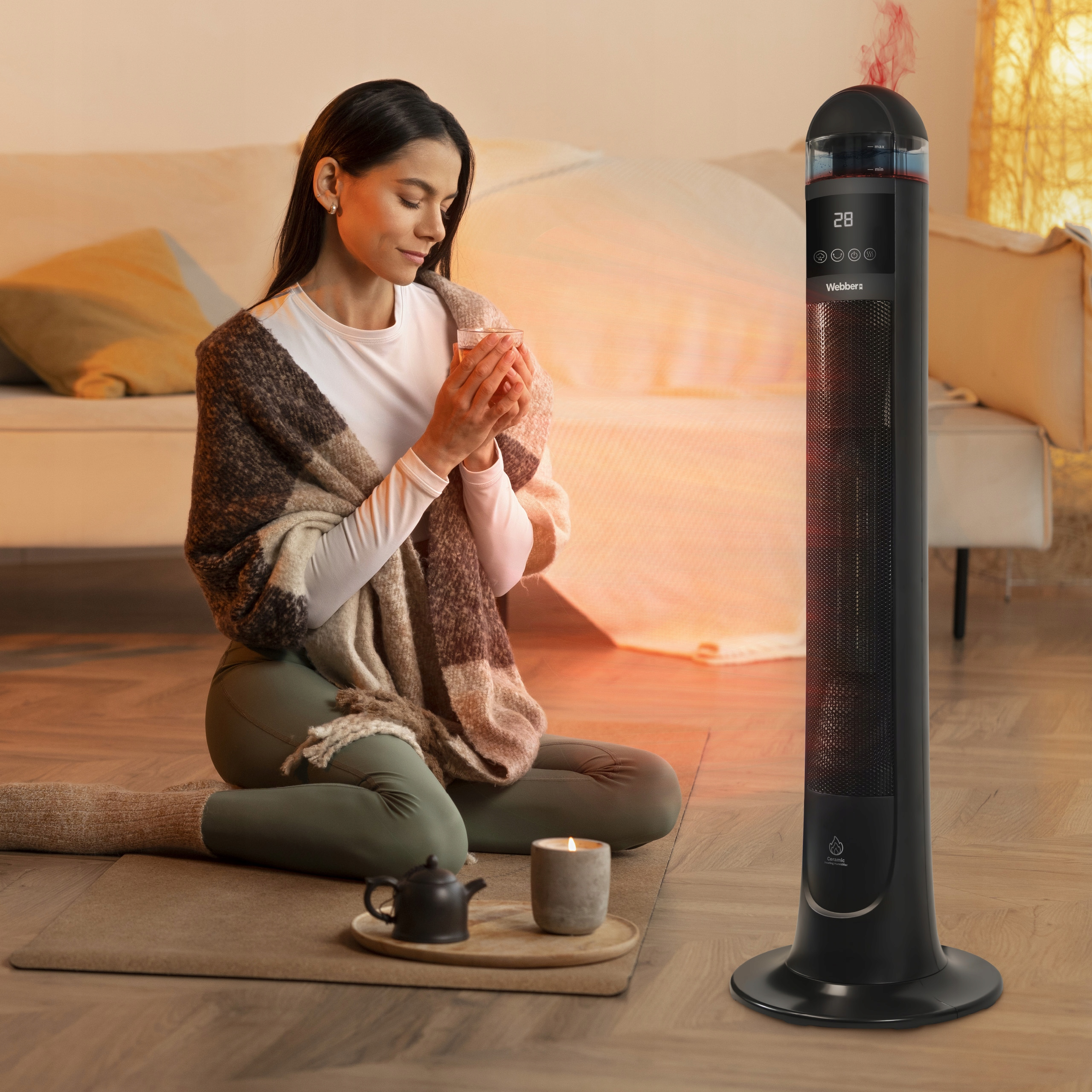 Kobieta pije herbatę obok grzejnika wydzielającego czerwony dym.