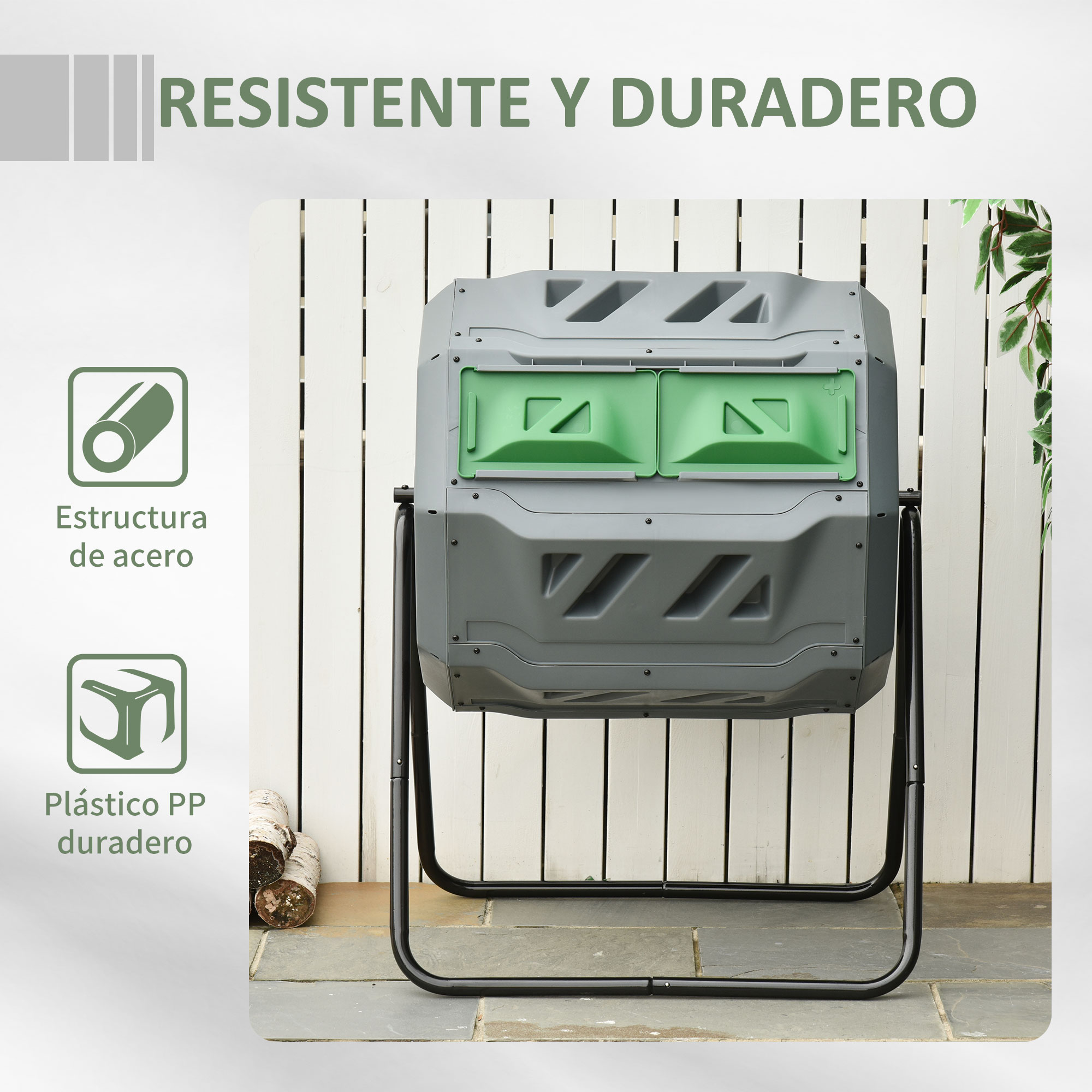 Compostador gris con puertas verdes sobre soporte negro ante valla blanca.