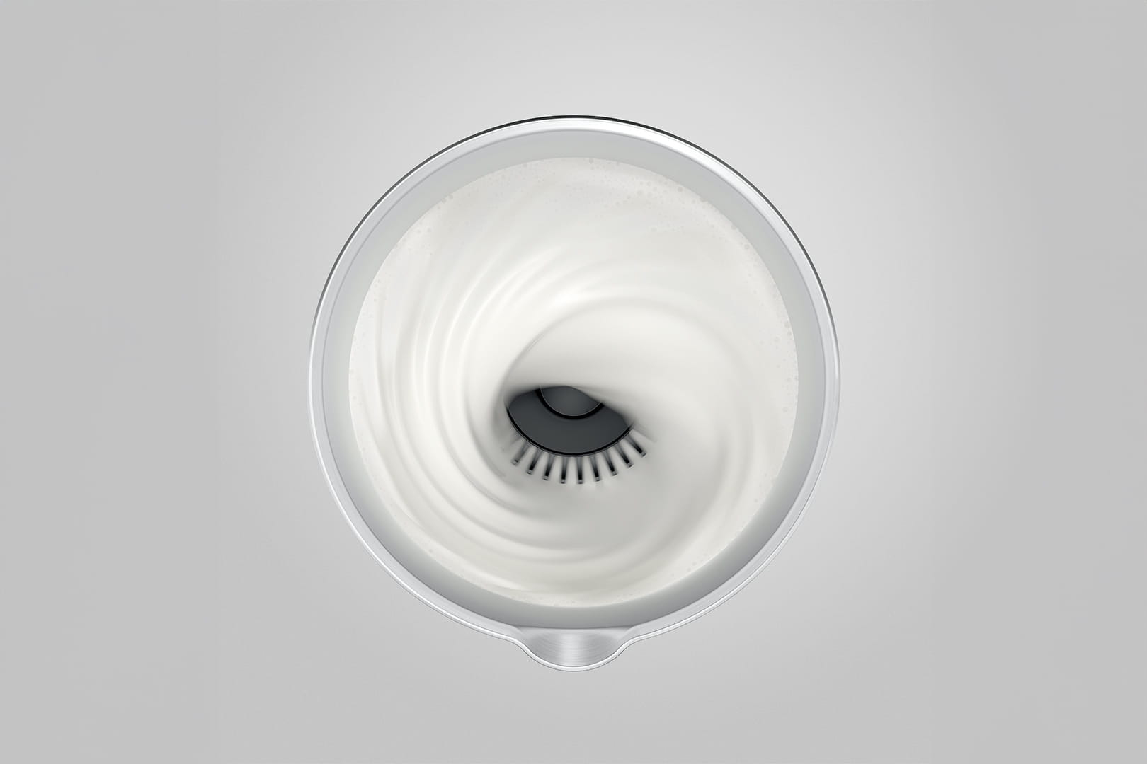 Liquido bianco turbina in un contenitore attorno a un inserto nero.