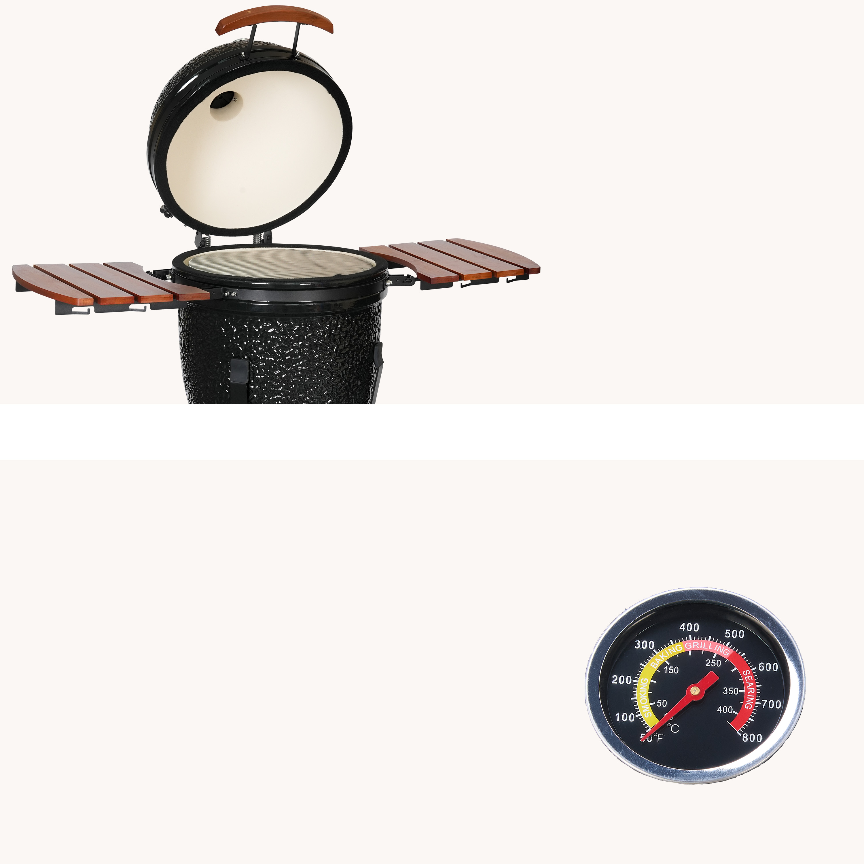 An open black ceramic grill with wooden side tables and a thermometer nearby.