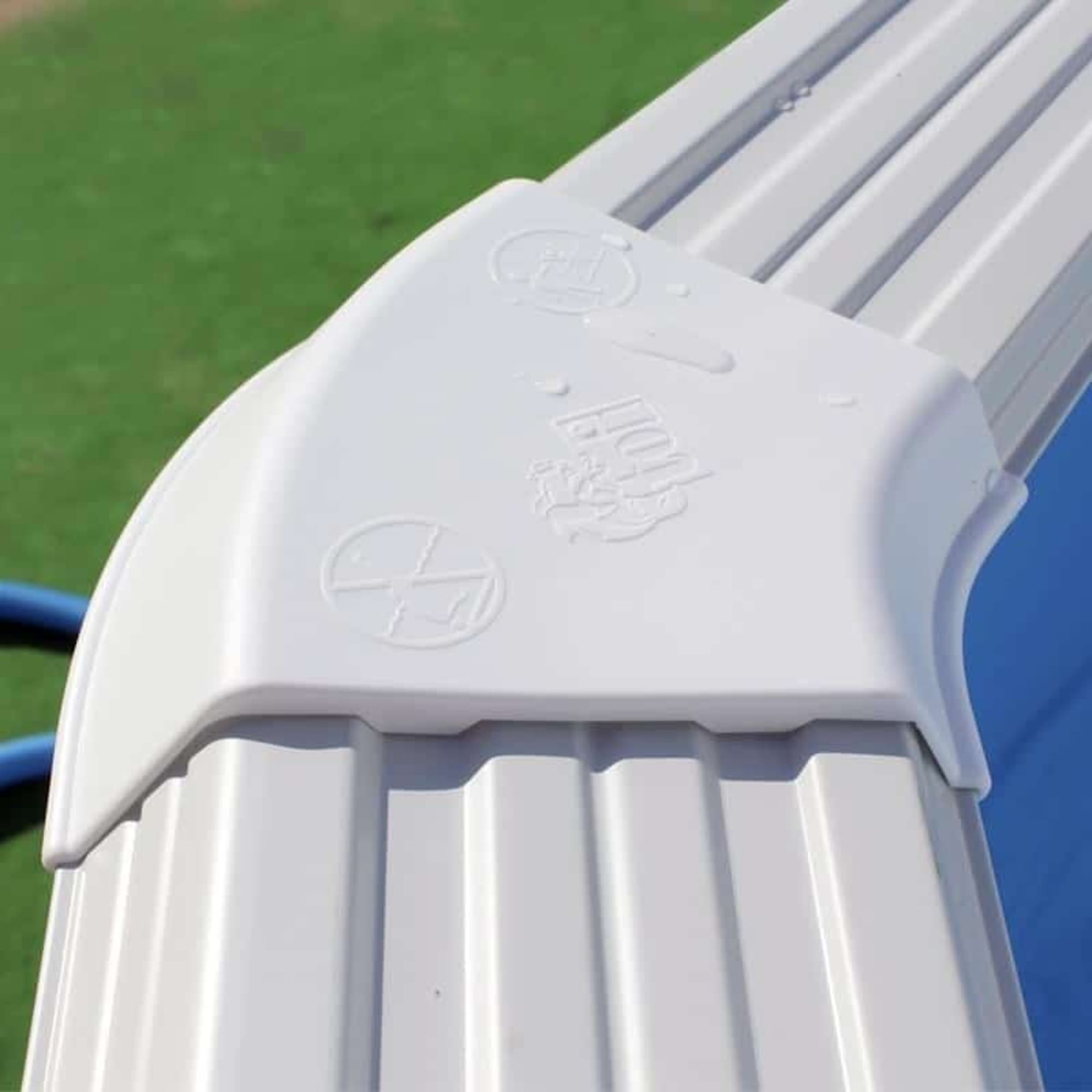 Canaleta blanca con logo en relieve y gotas de agua sobre fondo verde.