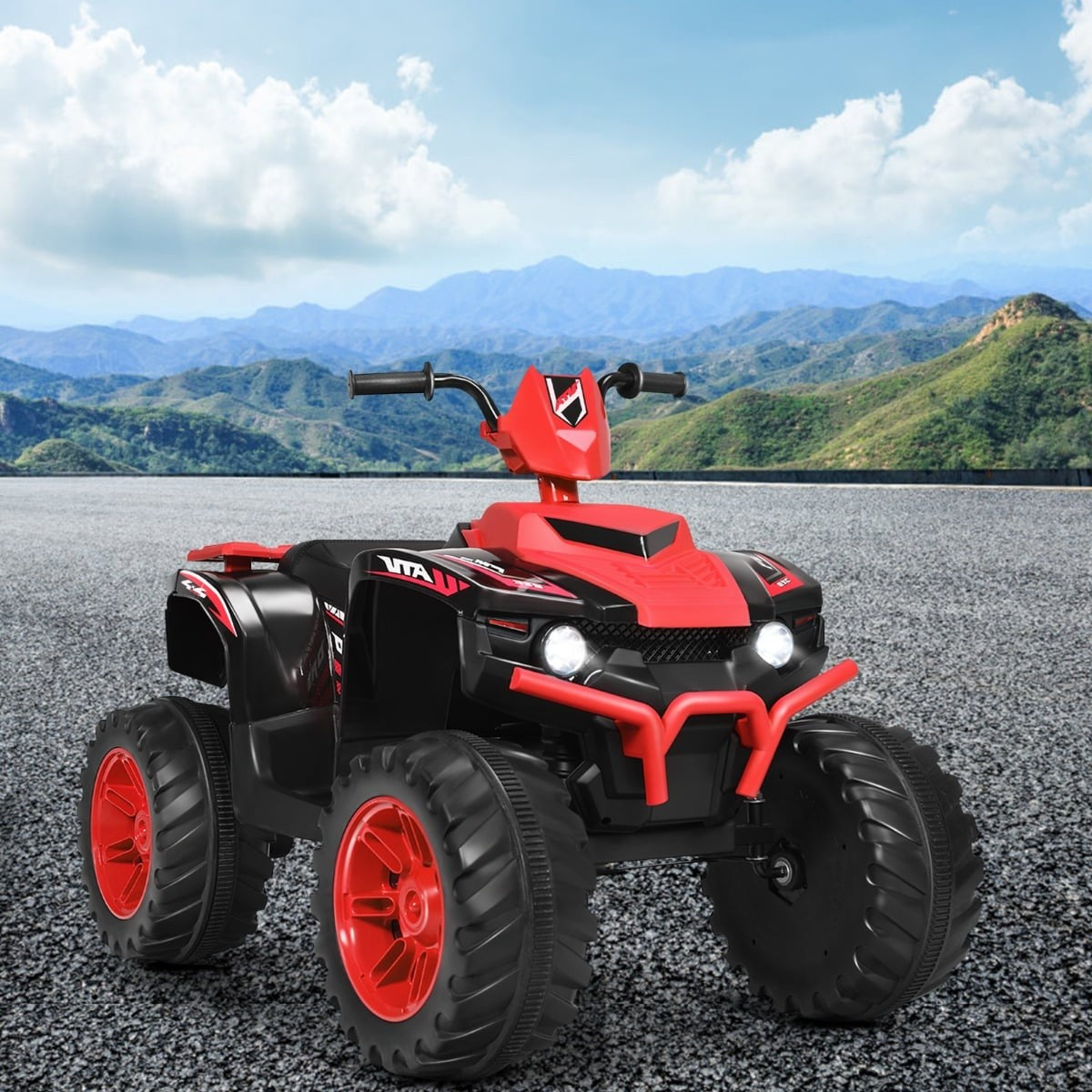 Un quad infantil rojo y negro con ruedas grandes sobre asfalto.