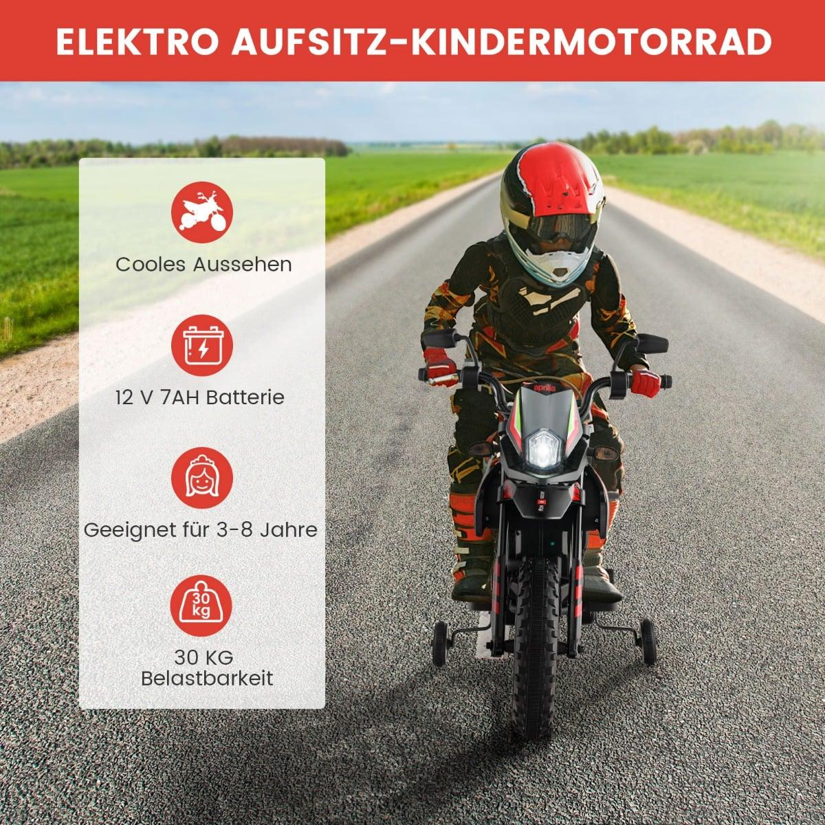 Niño con ropa de moto monta moto eléctrica de juguete en carretera.