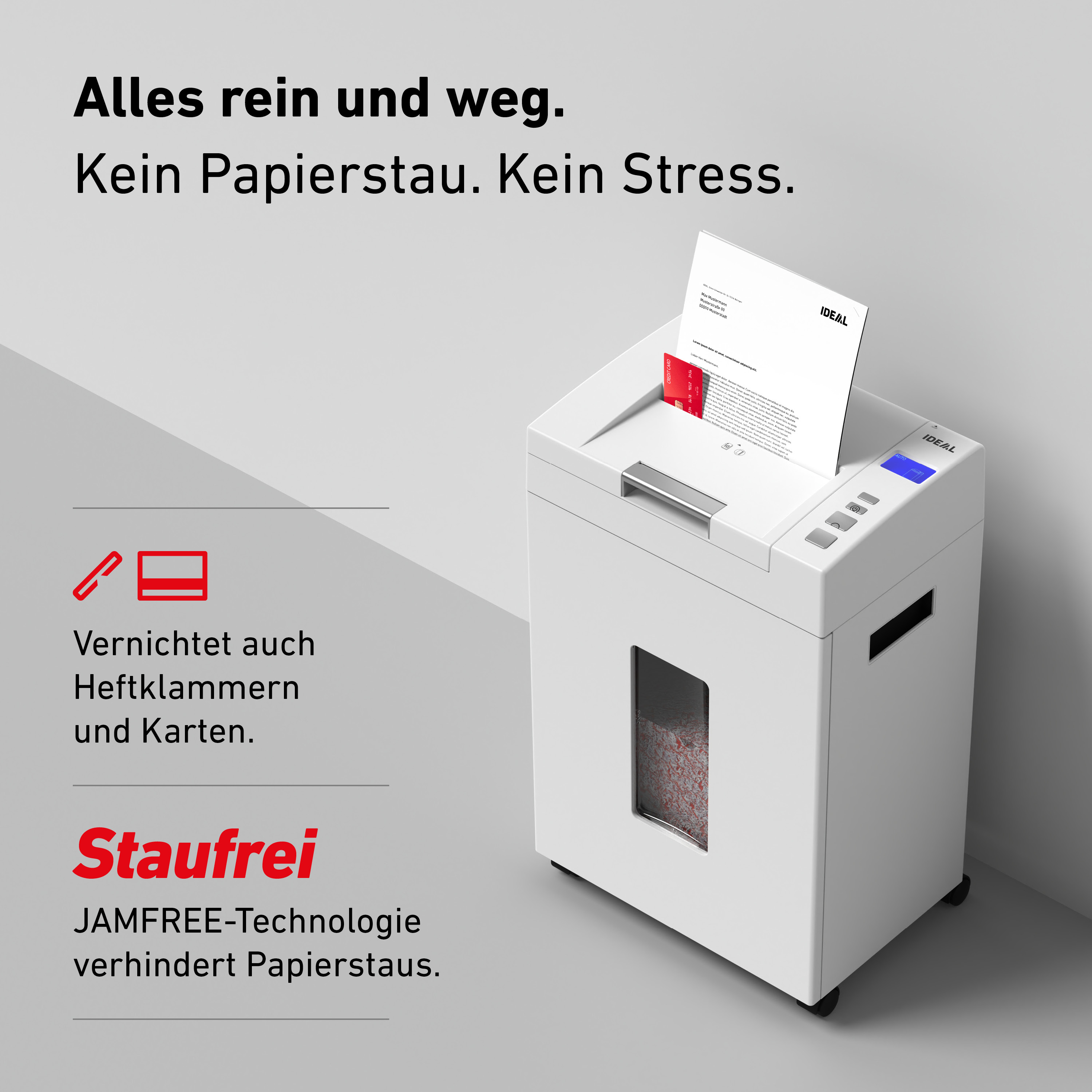 Ein weißer Aktenvernichter zerkleinert Papier und eine Kreditkarte.