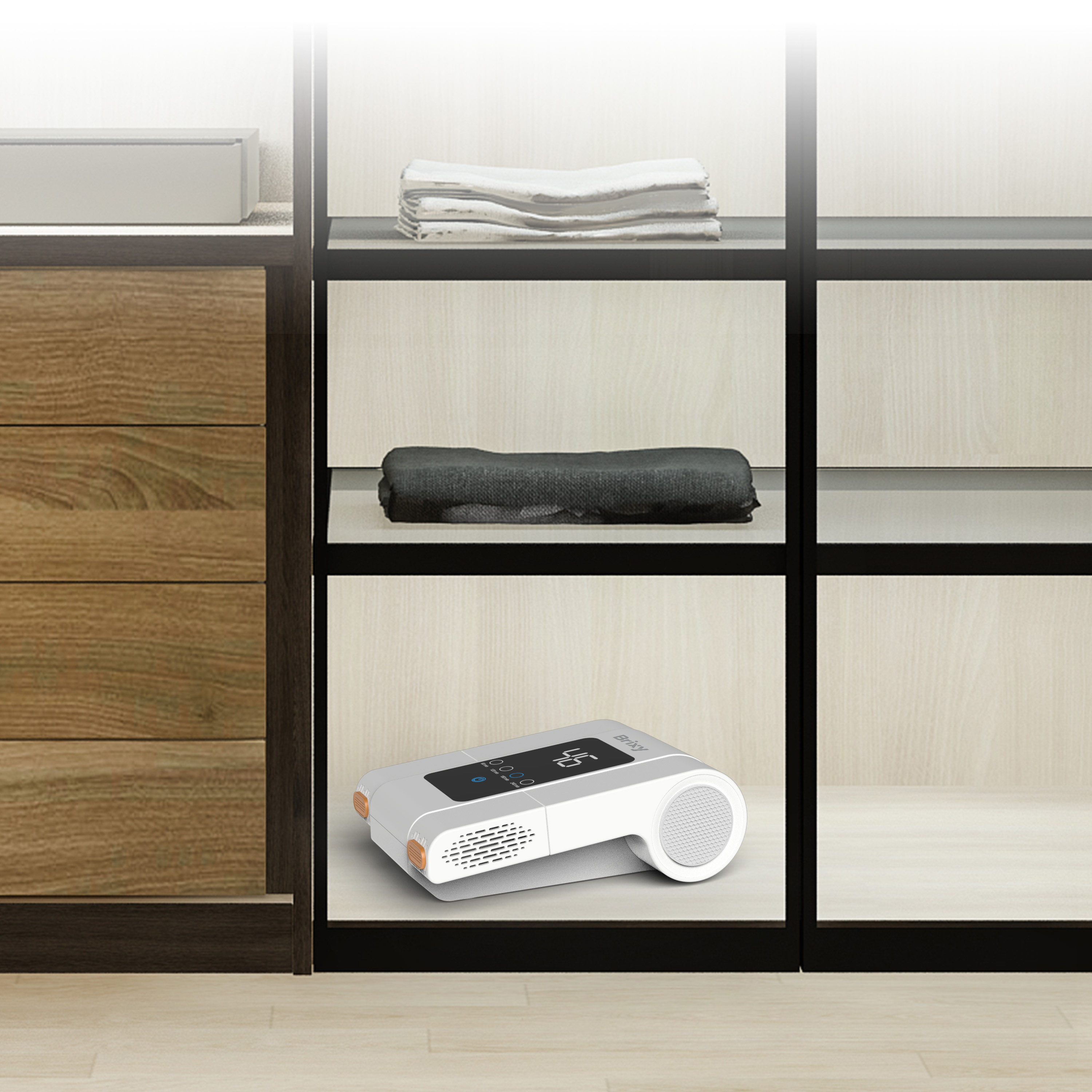 A white device with a display and speaker on a shelf.