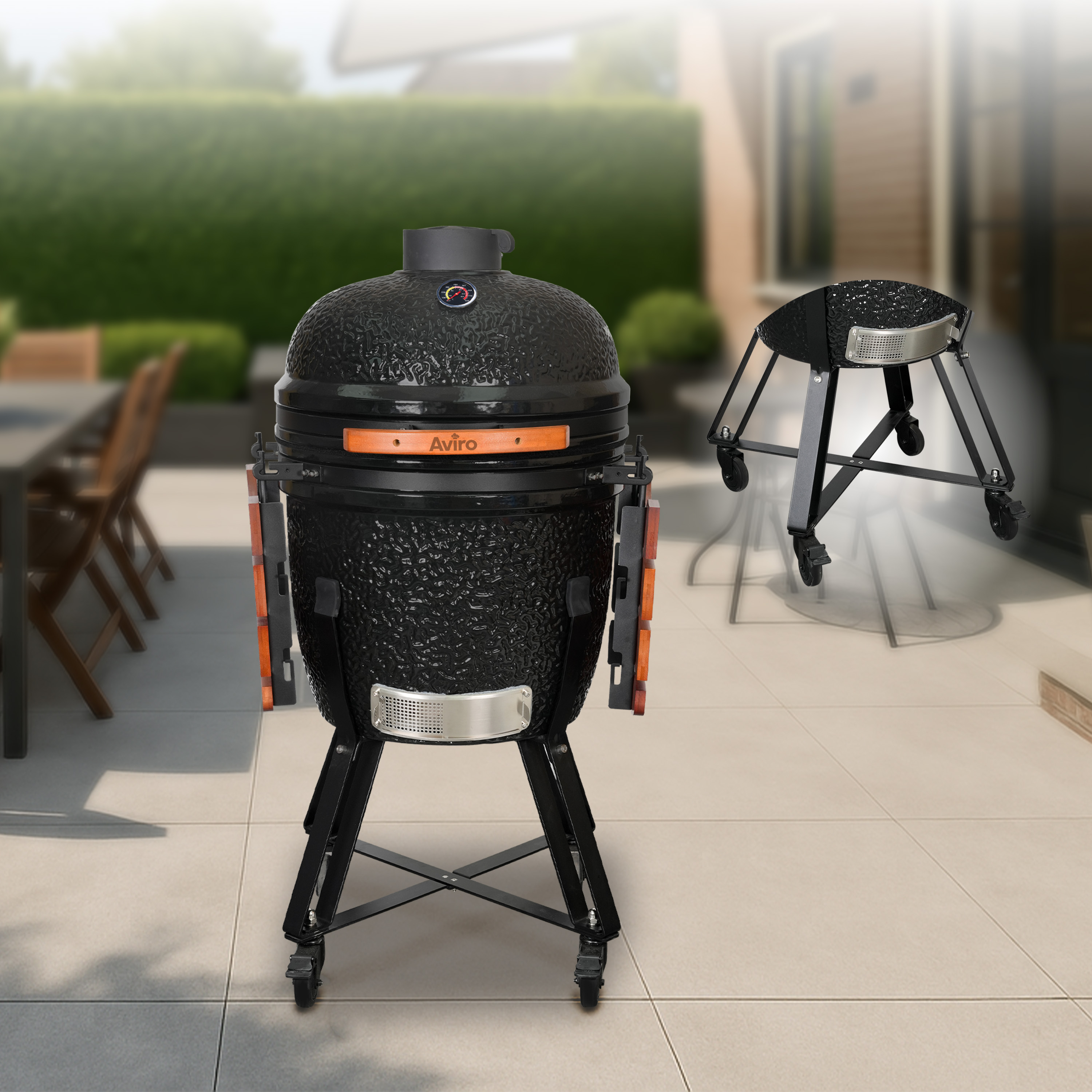 Black ceramic grill with thermometer and wooden handles on a patio floor.