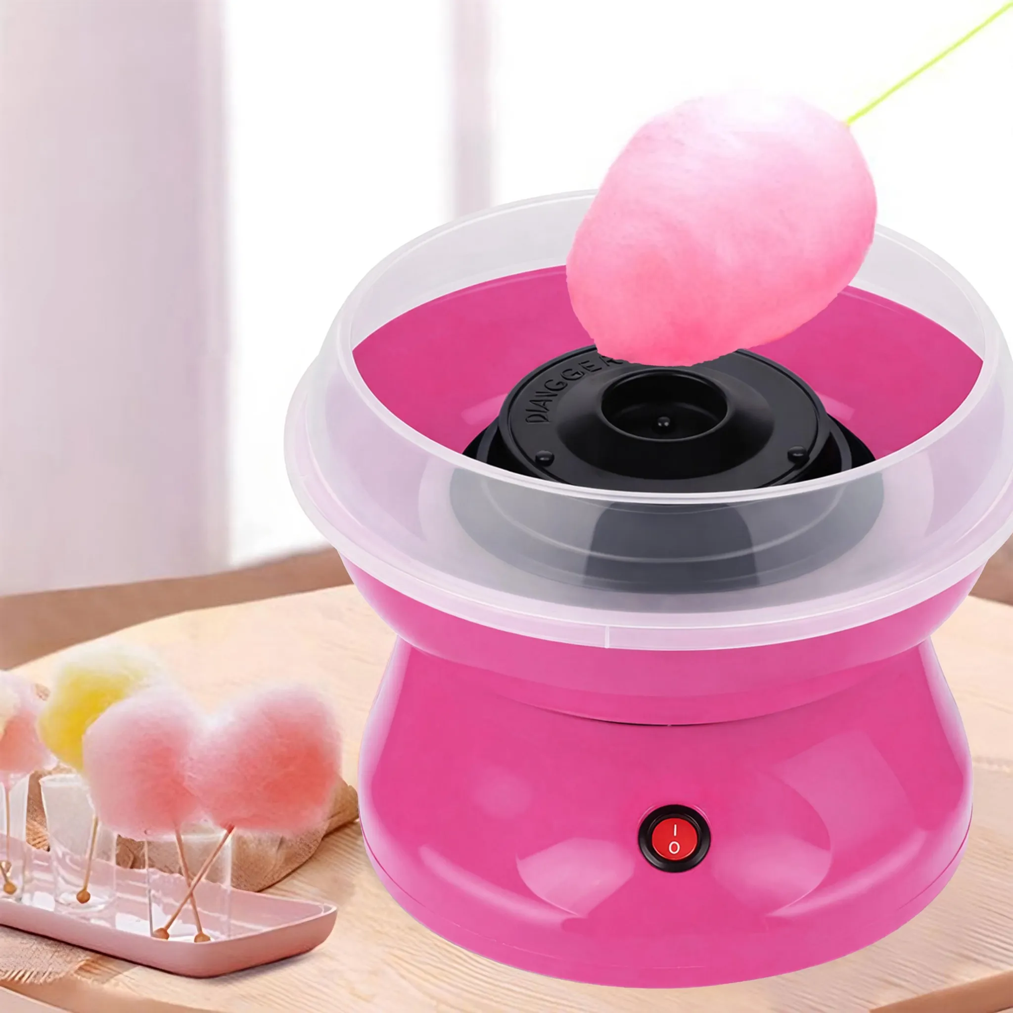 Ein rosafarbener Zuckerwattemaschine mit einem rosa Zuckerwattestrudel.