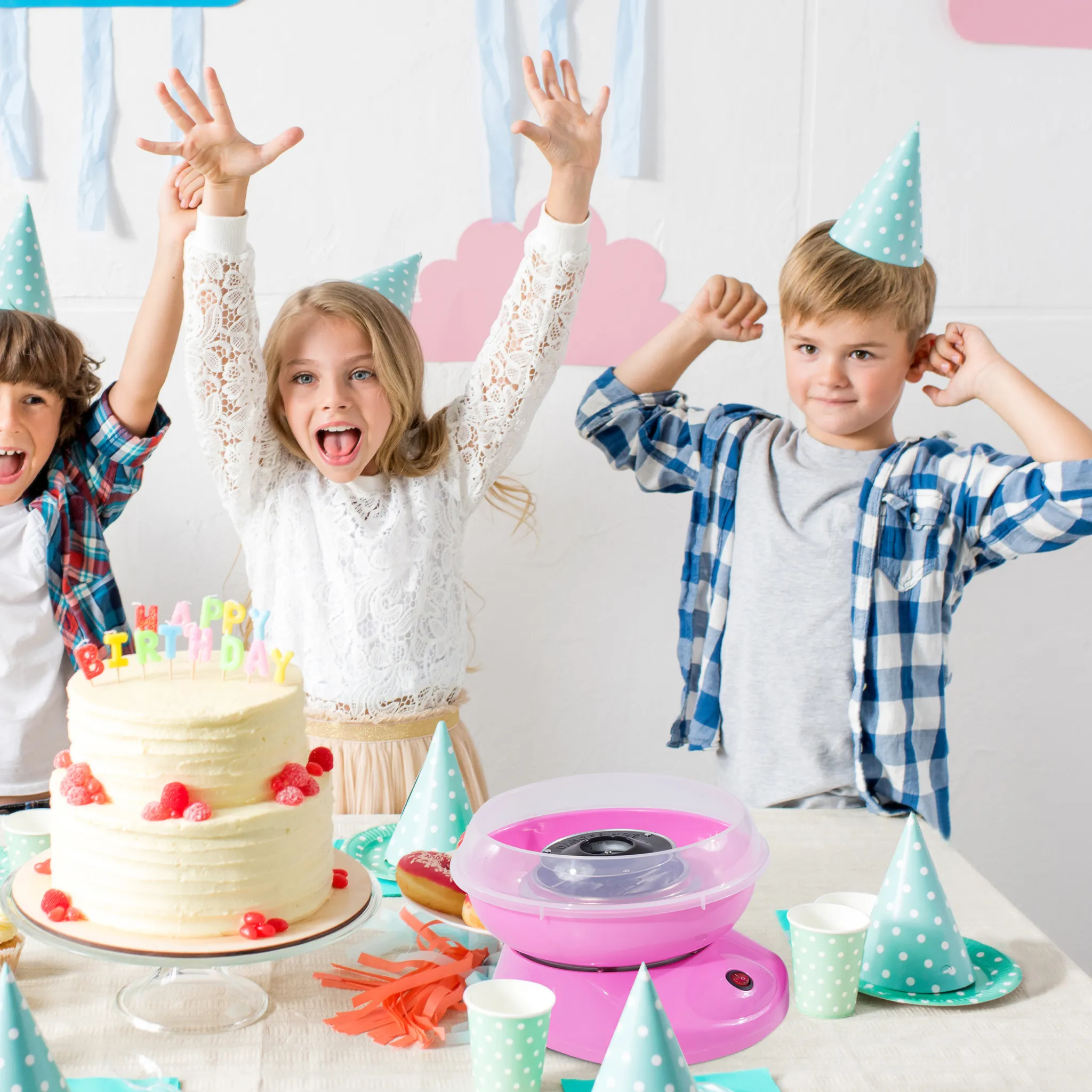 Kinder feiern Geburtstag mit Kuchen, Zuckerwatte und Partyhüten.