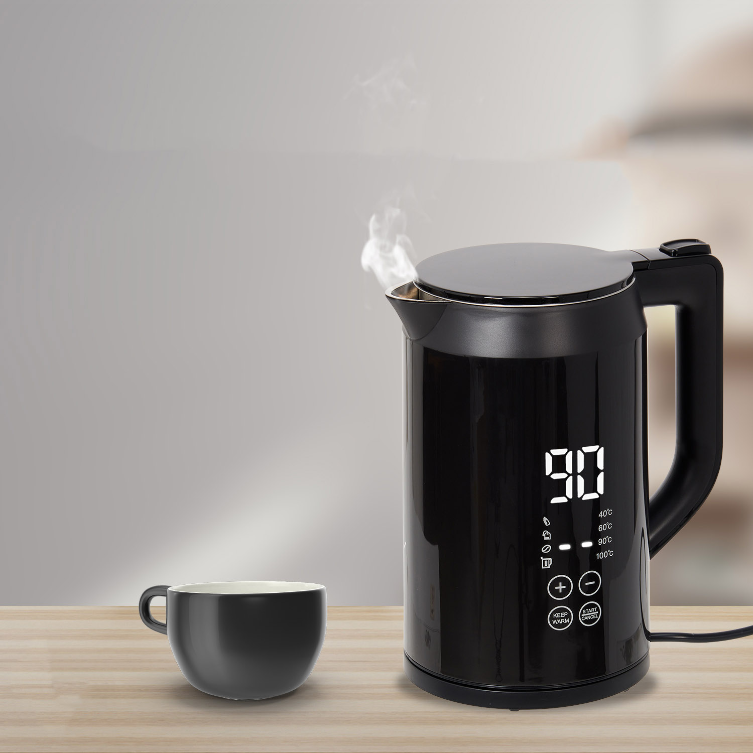 Black electric kettle with digital display showing 90°C next to a black cup.