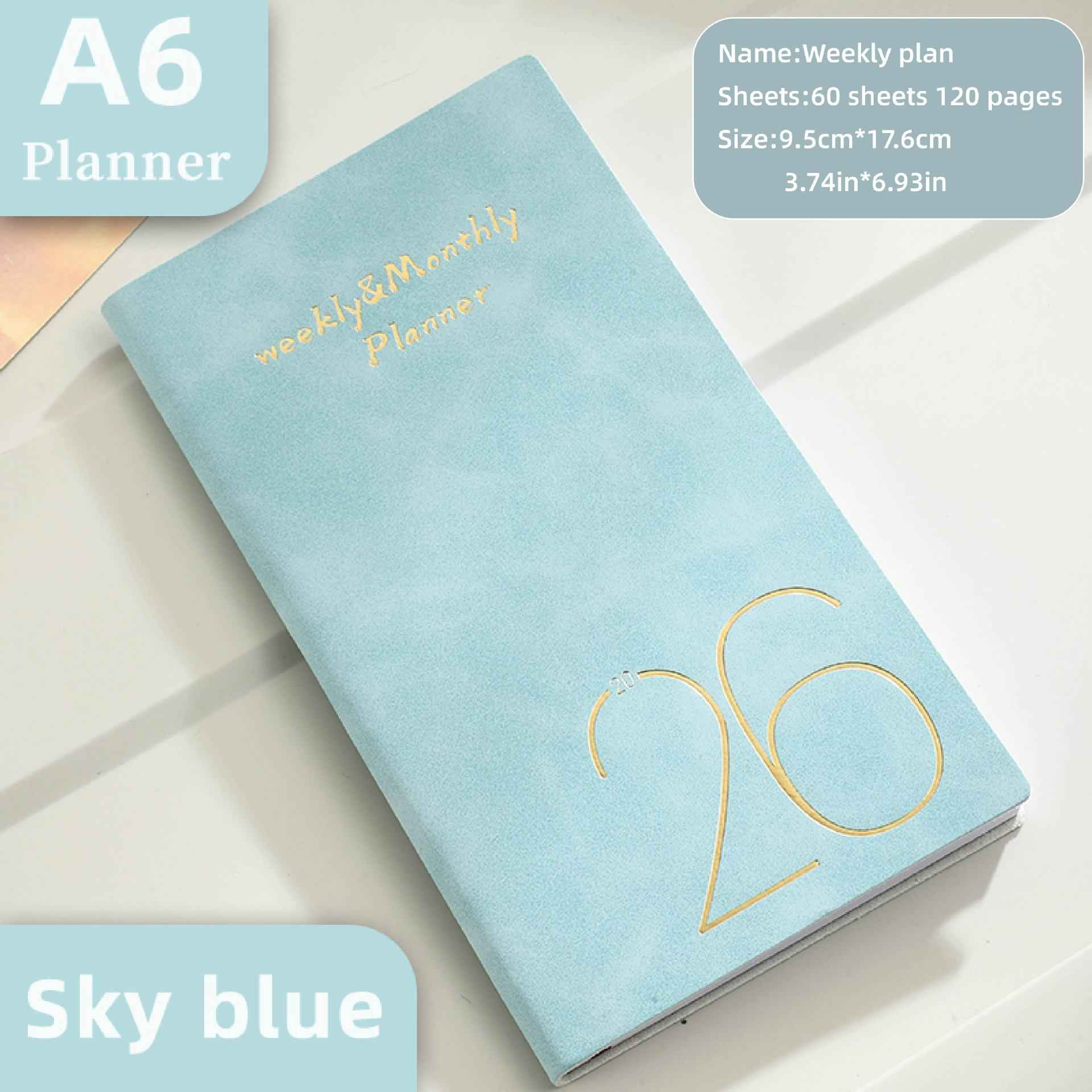 Ein hellblauer Planer mit der Aufschrift 'Weekly & Monthly Planner' und der Jahreszahl '26'.