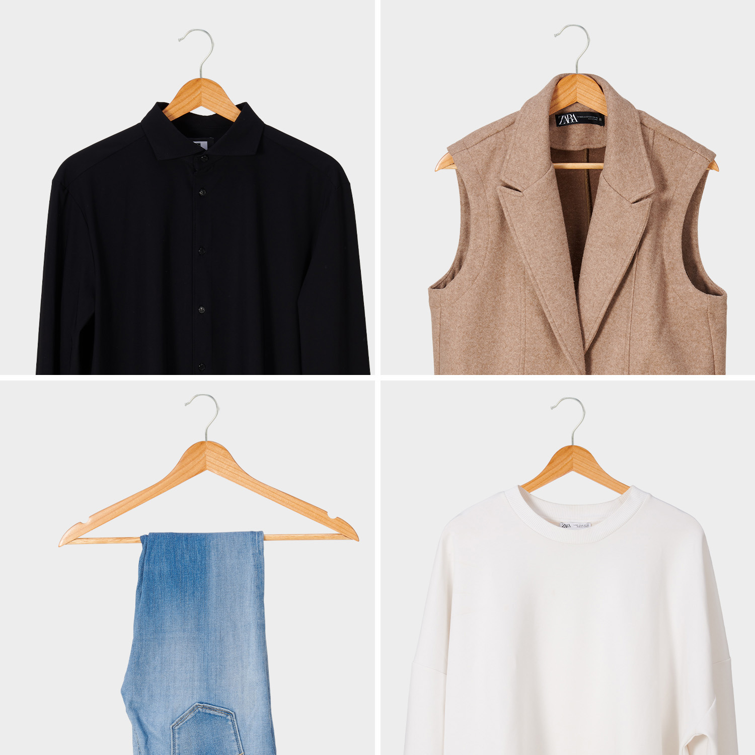 Vier kledingstukken aan hangers: zwart shirt, beige vest, blauwe spijkerbroek, witte sweater.