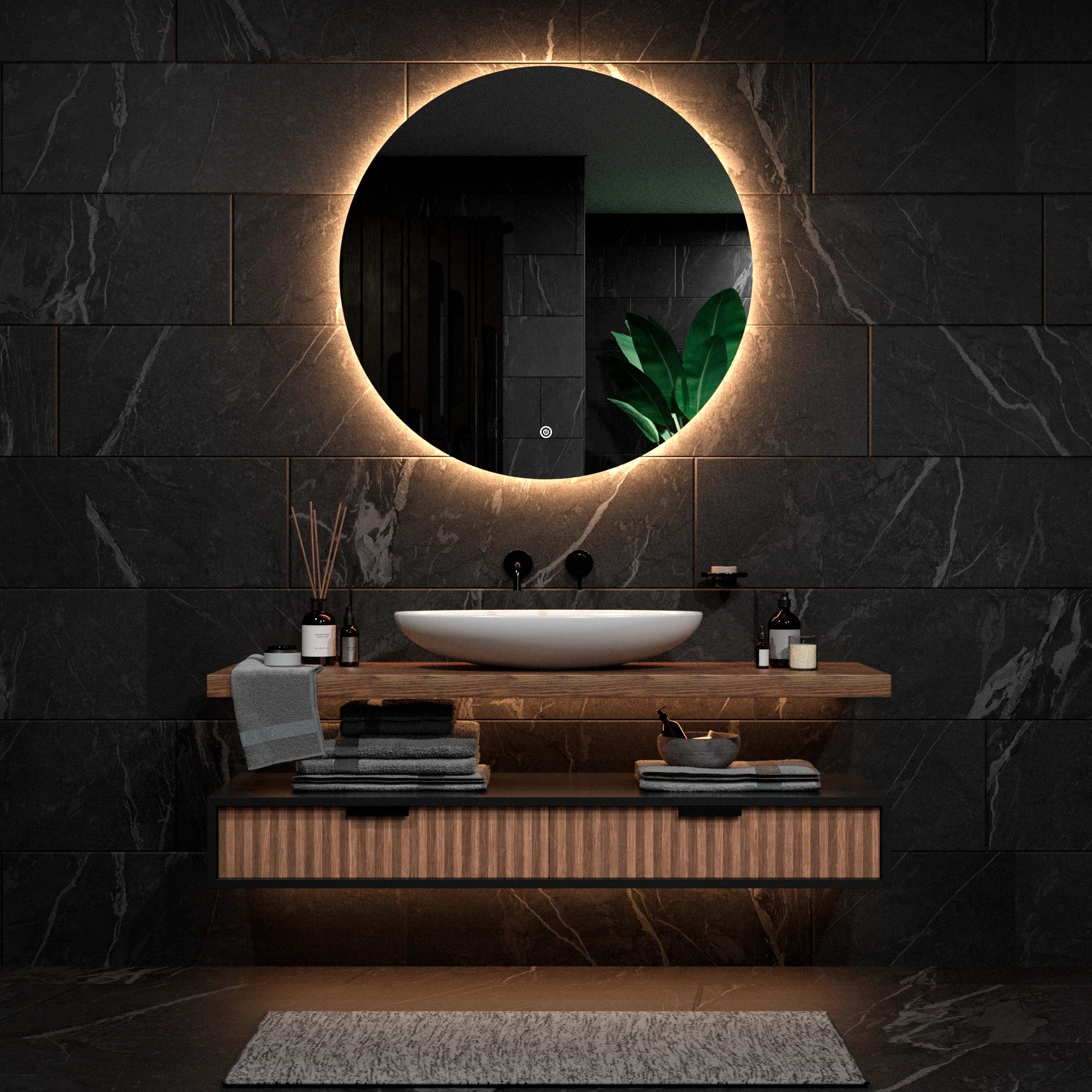A modern bathroom featuring a backlit mirror, sink, and dark tile walls.