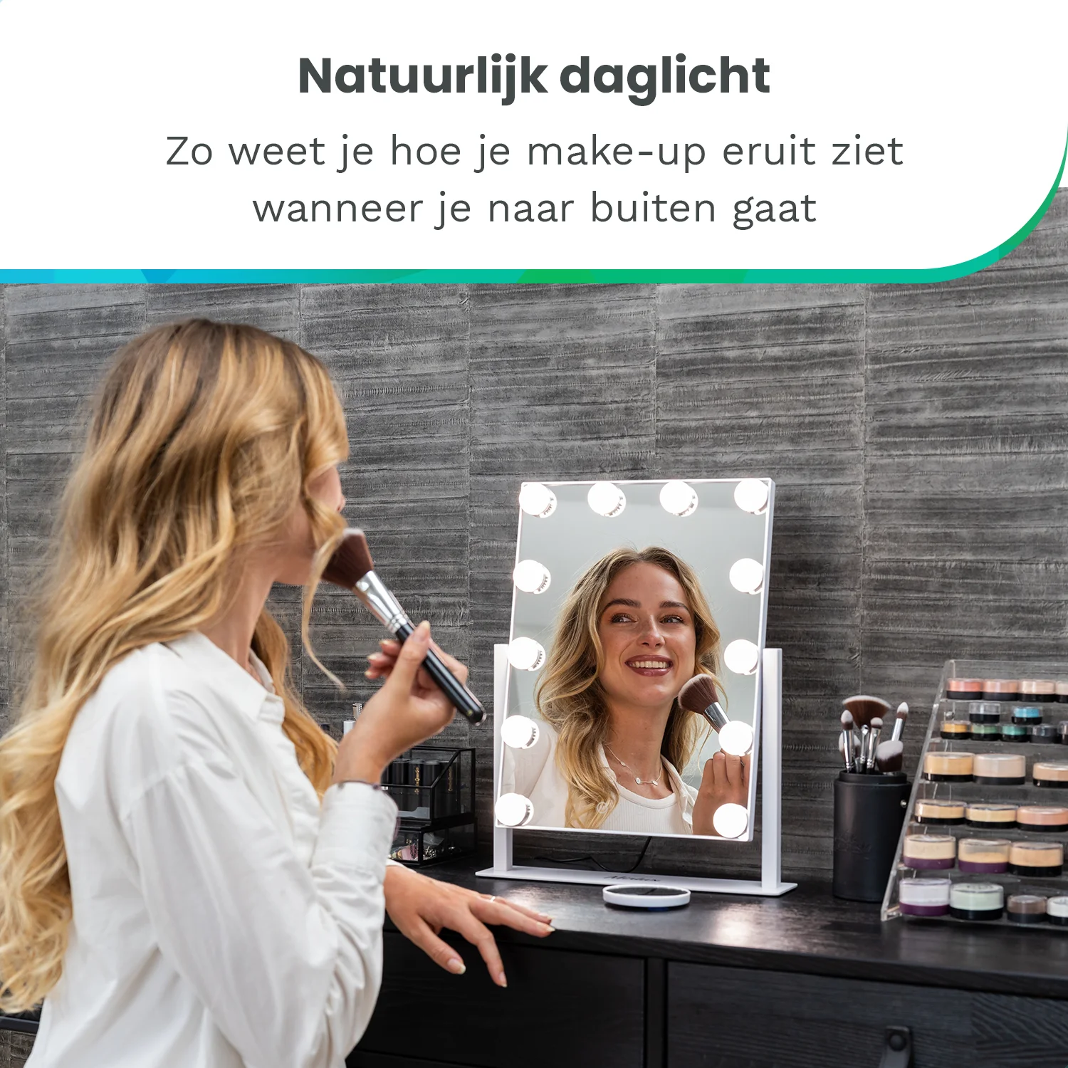 A woman with blonde hair applies makeup in front of a lighted mirror.