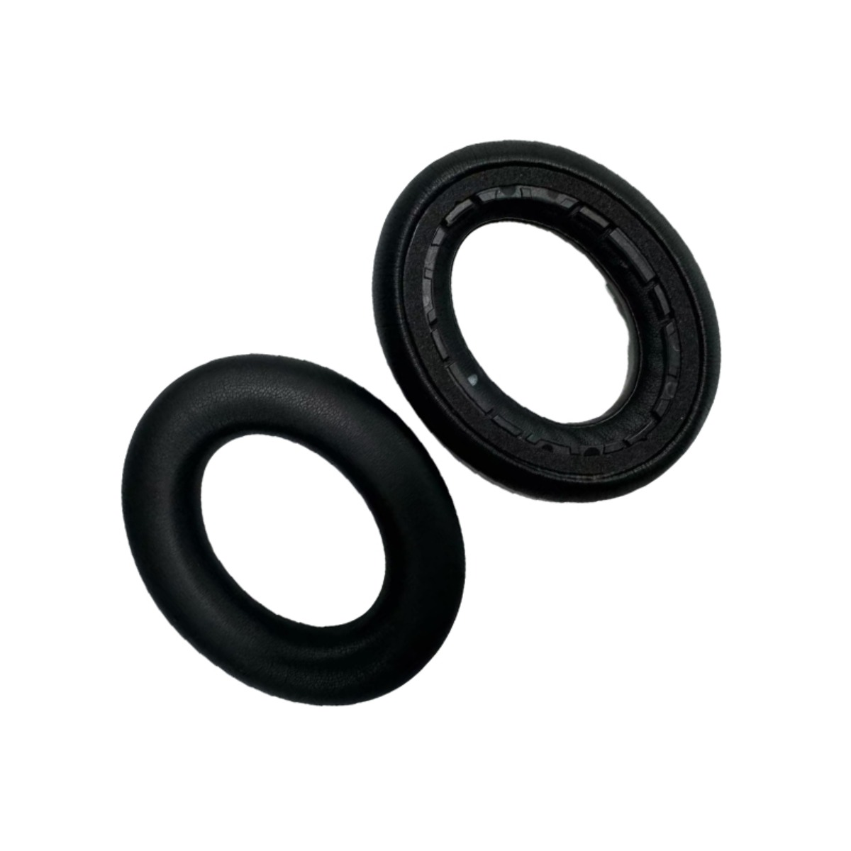 Two black headphone ear cushions on a white background.