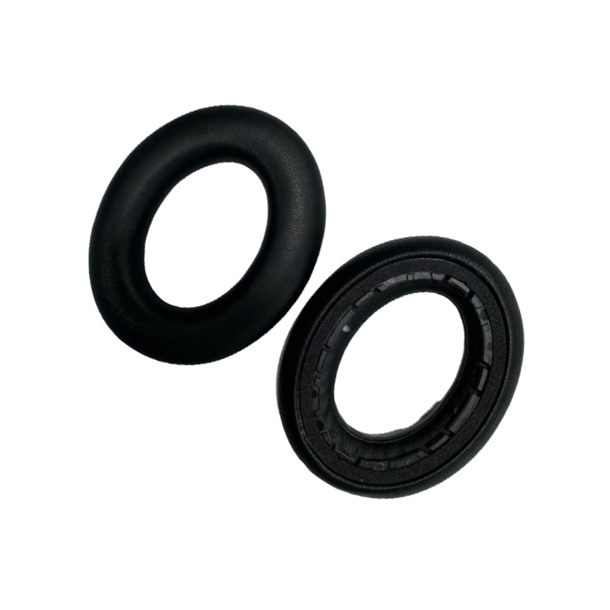 Two black ear pads, one with fabric cover, one showing inner edges.