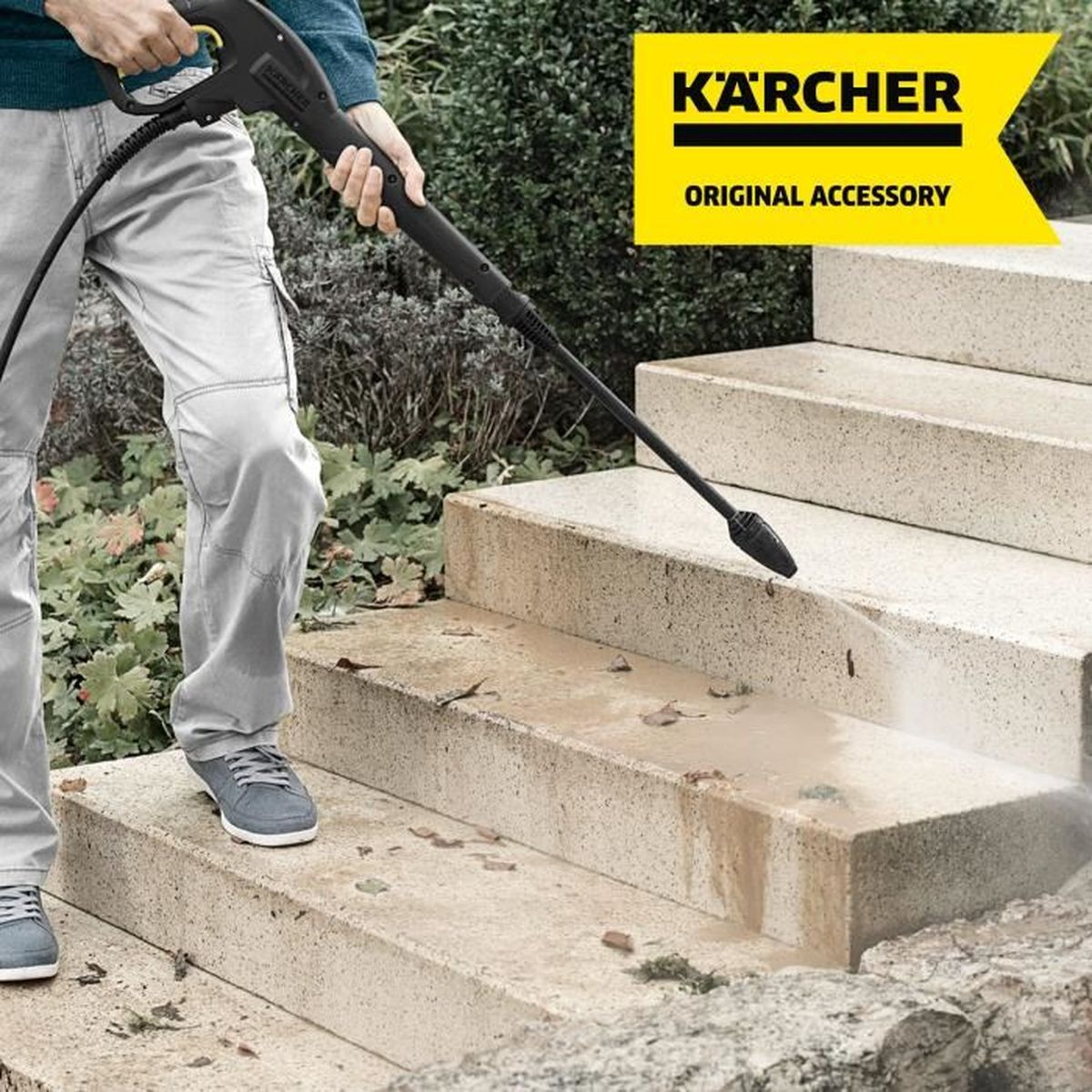 Person cleaning stone steps with a pressure washer, Karcher logo.