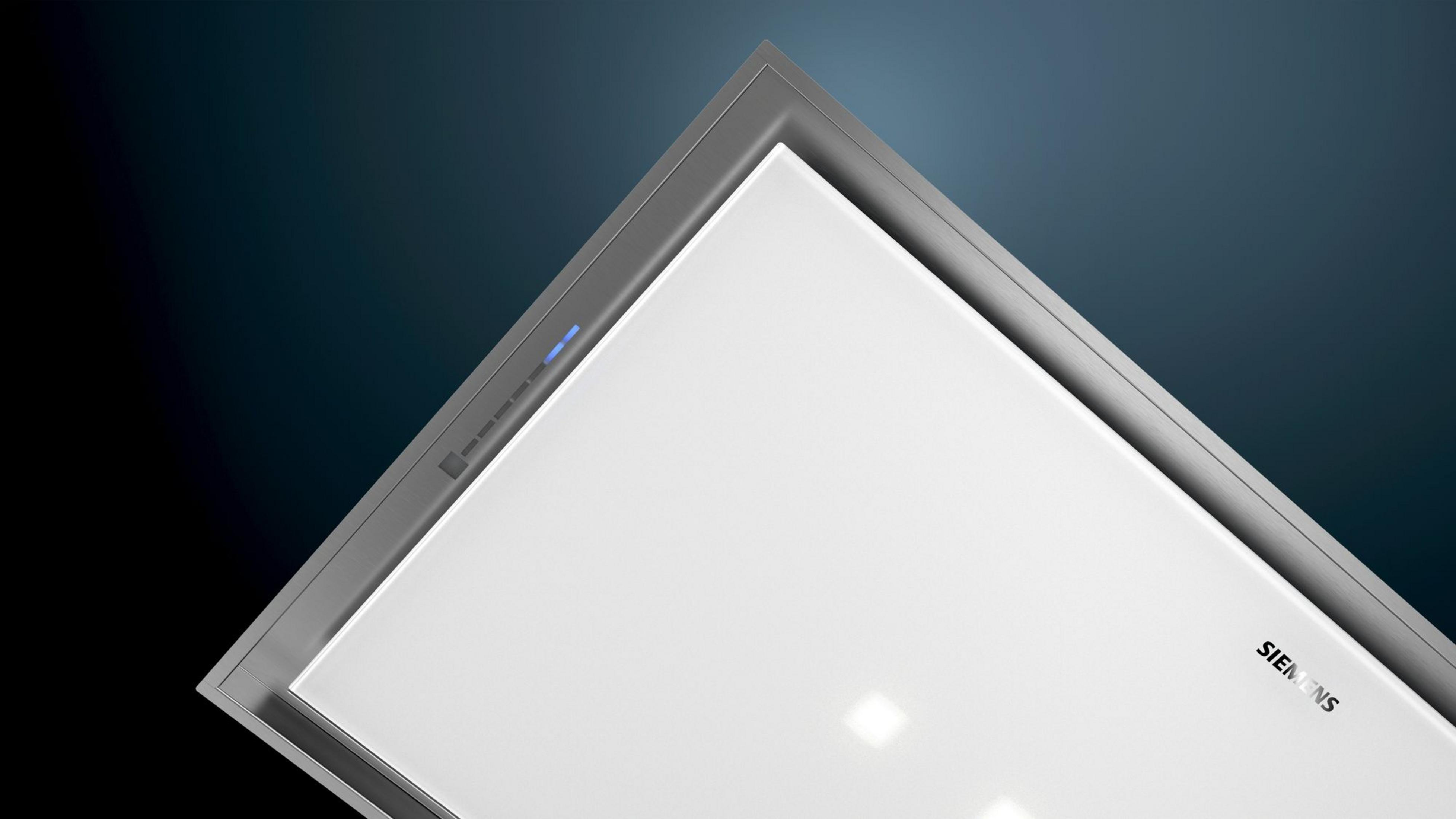 Modern range hood with silver frame and white surface, blue lights.