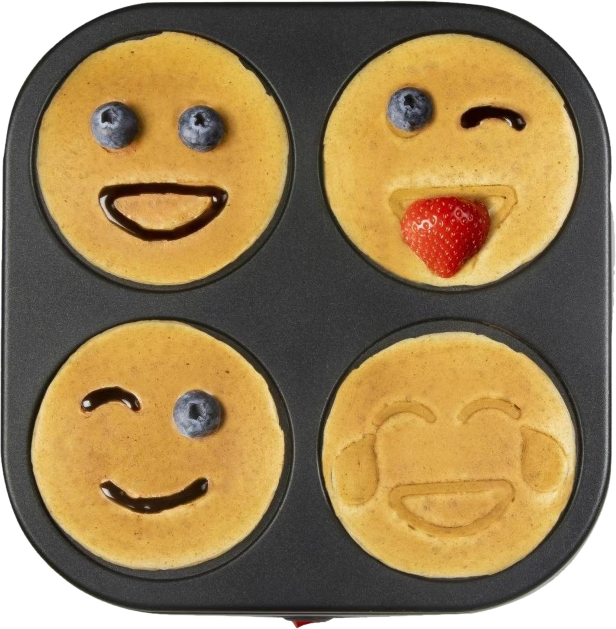 Naleśniki ozdobione jako emotikony w czarnej formie z jagodami i truskawkami.